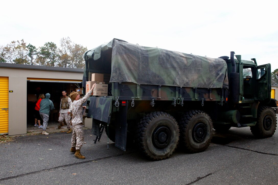 Marines unload a 7-ton truck stocked with disaster relief materials purchased and donated by Kirstie Alley, an actress known for her role in the TV show Cheers, to a post Hurricane distribution site in Toms River N.J., Nov. 3, 2012. Following Hurricane Sandy, Marines from 6th Motor Transport Battalion, 4th Marine Logistics Group, utilized their 7-ton trucks to move donated relief supplies to distribution points amongst the most heavily affected areas. 