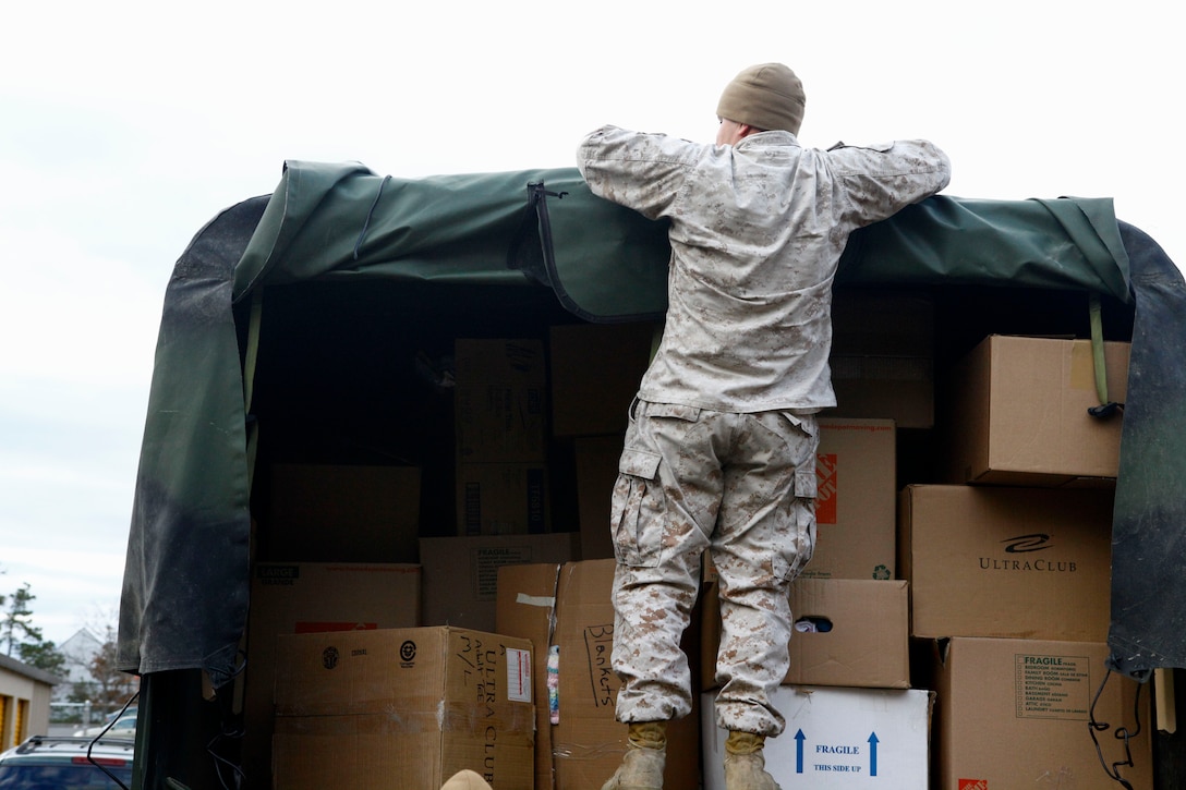 Marine Sgt. Eduardo Rivera, a motor transport operator and Dover N.J. native prepares to unload much-needed donations in the form of diapers, canned foods, clothes and blankets at a relief distribution site in Toms River N.J., Nov. 3, 2012. Following Hurricane Sandy, Marines from 6th Motor Transport Battalion, 4th Marine Logistics Group, utilized their 7-ton trucks to move donated relief supplies to distribution points amongst the most heavily affected areas. 