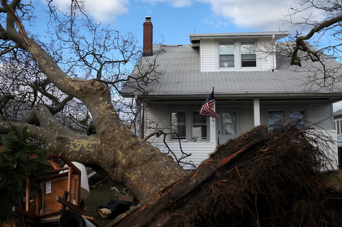 A United States flag flies in the background amidst debris and destruction caused by Hurricane Sandy in Toms River N.J., Nov. 3, 2012. Following Hurricane Sandy, Marines from 6th Motor Transport Battalion, 4th Marine Logistics Group, utilized their 7-ton trucks to move donated relief supplies to distribution points amongst the most heavily affected areas. 