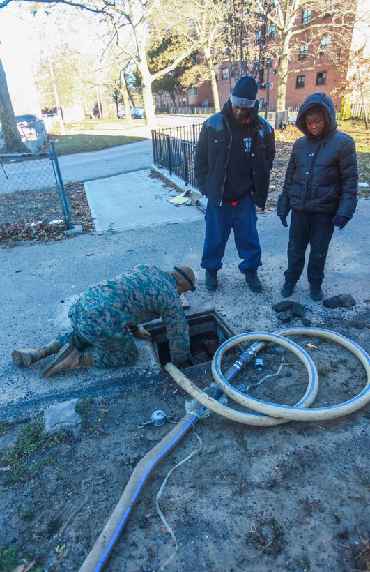 Sgt. Ryan Ewing, a native of Lancaster, Ohio, a water support technician with a detachment of 8th Engineer Support Battalion, 2nd Marine Logistics Group based out of Camp Lejeune, N.C., prepares a hose to excavate the water from the basement of an apartment complex in Far Rockaway, N.Y. on Nov. 4. The detachment of Marines from 8th ESB volunteered to help aide the victims of the cities that were effected by Hurricane Sandy.  (Official Marine Corps photo by Cpl. Caleb Gomez)