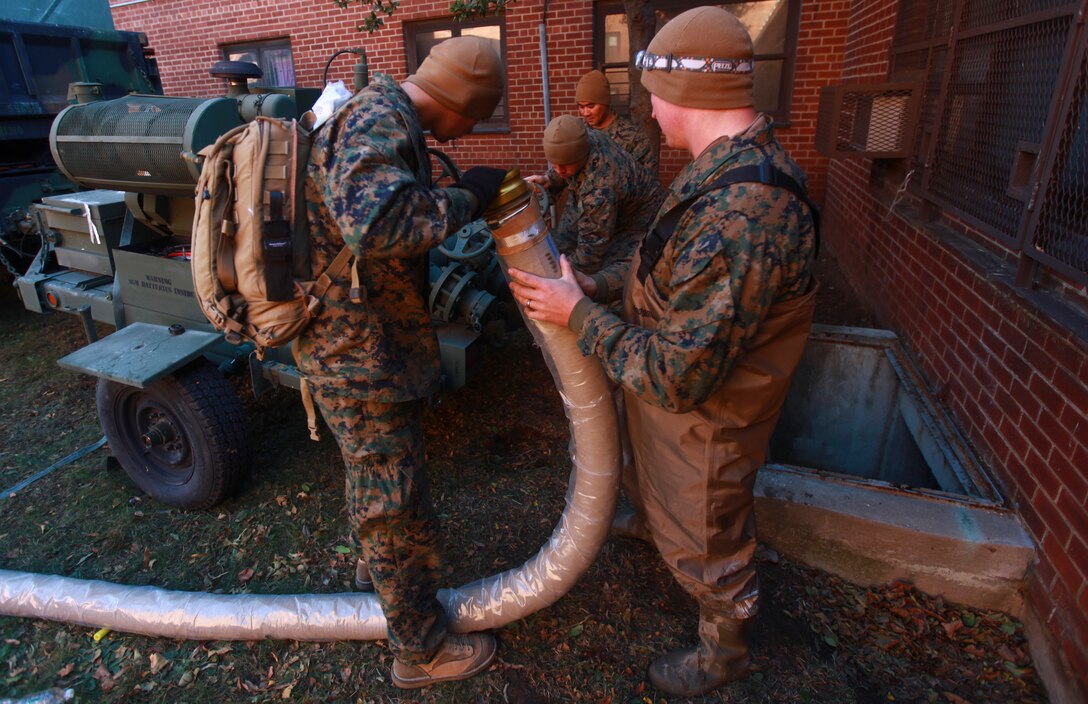 Marines with a detachment from 8th Engineer Support Battalion, 2nd Marine Logistics Group based out of Camp Lejeune, N.C., set up a water pump to clear out the basement of an apartment complex in Far Rockaway, N.Y. on Nov. 4.The detachment of Marines volunteered to help aide the victims of the cities that were effected by Hurricane Sandy.  (Official Marine Corps photo by Cpl. Caleb Gomez)