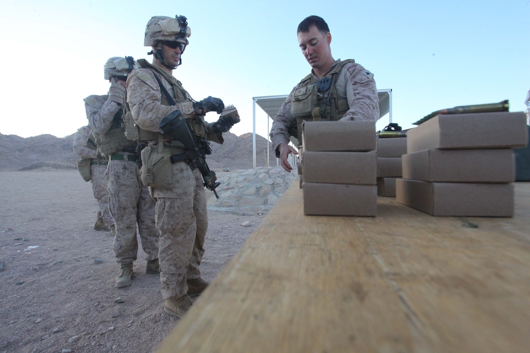 JORDAN (Oct. 11, 2012)  U.S. Marines assigned to Marine Engagement Team from Battalion Landing Team 1st Battalion, 2nd Marine Regiment, 24th Marine Expeditionary Unit, prepare to hand out ammunition prior to conducting a live fire training exercise, Oct. 11, 2012. The engagement team is a platoon-sized group of Marines from the 24th MEU who are conducting a variety of unilateral and bilateral training events with the Jordanian Marines in southern Jordan. The 24th MEU is deployed with the Iwo Jima Amphibious Ready Group as a U.S. Central Command theater reserve force, providing support for maritime security operations and theater security cooperation efforts in the U.S. 5th Fleet area of responsibility. (U.S. Marine Corps photo by Lance Cpl. Tucker S. Wolf/Released)