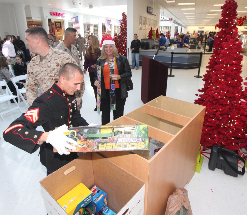 Cpl. Ryan A. Moszcienski, a landing support specialist with 2nd Landing Support Battalion, 4th Marine Logistics Group, collects toys during the Marine Corps Reserve Toys for Tots program collection kickoff at the Marine Corps Exchange aboard Marine Corps Base Camp Lejeune Nov. 1. Collections started Nov. 1 and will end Dec. 14.