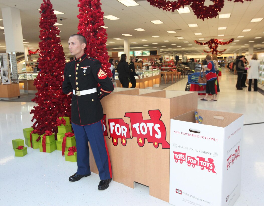 Cpl. Ryan A. Moszcienski, a landing support specialist with 2nd Landing Support Battalion, 4th Marine Logistics Group, waits to collect toys during the Marine Corps Reserve Toys for Tots program collection kickoff at the Marine Corps Exchange aboard Marine Corps Base Camp Lejeune Nov. 1. Collections started Nov. 1 and will end Dec. 14.