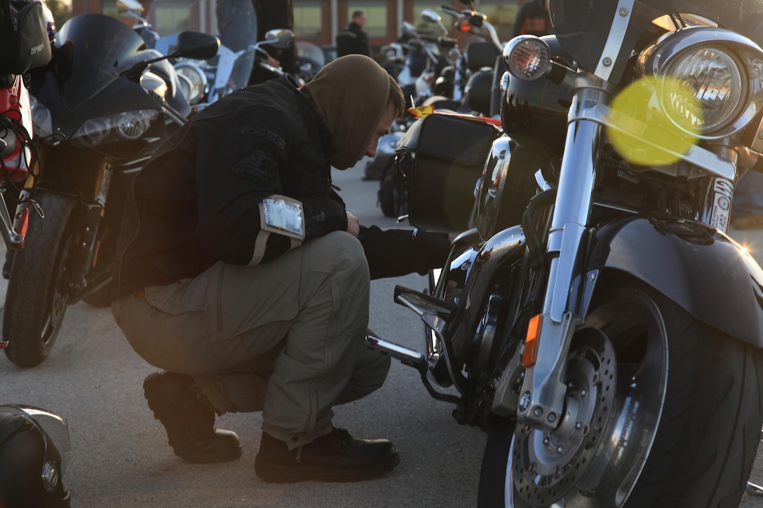 A Marine with U.S. Marine Corps Forces, Special Operations Command conducts a motorcycle safety inspection before embarking on an outing with MARSOC motorcycle operators Oct. 31, 2012 aboard Camp Lejeune, NC. The occasion marked the first time MARSOC's various motorcycle clubs assembled for a consolidated ride. "First and foremost, this outing was about safety," said Master Gunnery Sgt. George Lee, a rider with 15 years' experience. "It was also about camaraderie and mentorship." The riders drove to Wilmington for a tour of the USS North Carolina and to explore local hobby shops. Experience among the motorcyclists ranged from three months to upwards of 30 years. "It was definitely a worthwhile experience," said Lance Cpl. Roderick Kim, a small craft mechanic at MARSOC who is new to riding. "I learned how to ride with a group, learned how to space myself. It was good training."
