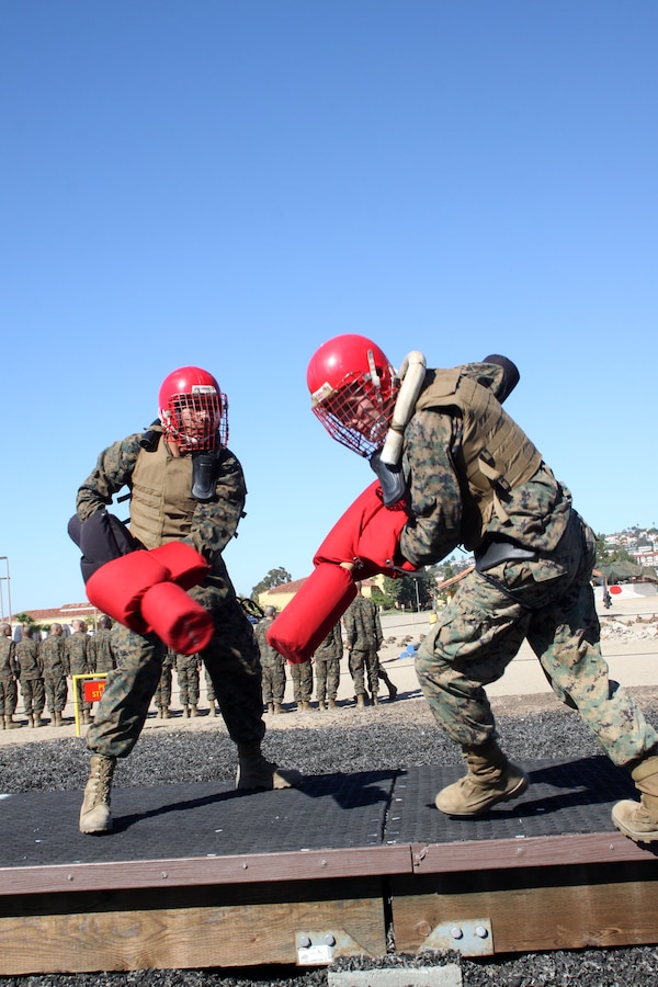 A recruit of Company I, 3rd Recruit Training Battalion, begins to fall off the pugil stick stage after being struck by a pugil stick aboard Marine Corps Recruit Depot San Diego, Oct. 29. The pugil stick bouts were designed to teach recruits the fundamentals of hand to hand combat. For some recruits it was their first time in a fight.