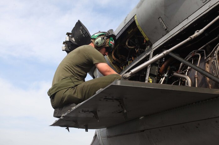 USS IWO JIMA (Nov. 5, 2012) - A Marine with Marine Medium Tiltrotor Squadron 261 (Reinforced), 24th Marine Expeditionary Unit, conducts engine maintenance on an MV-22B Osprey while transiting through the Suez Canal aboard the USS Iwo Jima, Nov. 5, 2012. The 24th MEU is deployed with the Iwo Jima Amphibious Ready Group and is currently in the 6th Fleet Area of Responsibility as a disaster relief and crisis response force. Since deploying in March, they have supported a variety of missions in the U.S. Central and European Commands, assisted the Navy in safeguarding sea lanes, and conducted various bilateral and unilateral training events in several countries in the Middle East and Africa. The 24th MEU  is scheduled to return to their home bases in North Carolina later this year. (U.S. Marine Corps photo by Lance Cpl. Tucker S. Wolf/Released)