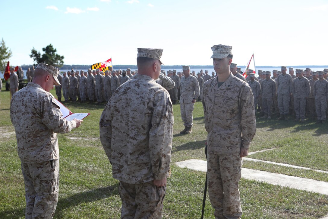Cpl. Ronald Carreathers, a field artillery canoneer with Golf battery, 2nd Battalion, 10th Marine Regiment, stands at the position of attention in front of Maj.  Ronnie Goode, the battalion executive officer for 2nd Battalion, 10th Marine Regiment, Oct. 31 at Camp Lejeune. Carreathers was awarded the Purple Heart for being wounded while serving as his battery's lead dog handler, while deployed to Helmand province, Afghanstan.