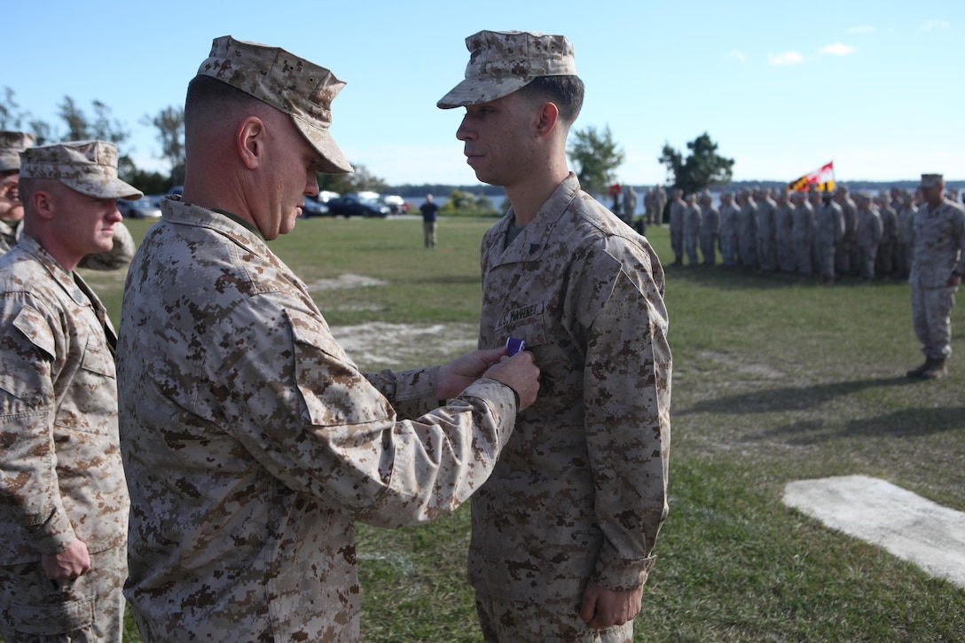 Cpl. Ronald Carreathers, a field artillery canoneer with Golf battery, 2nd Battalion, 10th Marine Regiment, is pinned with the Purple Heart by Maj.  Ronnie Goode, the battalion executive officer for 2nd Battalion, 10th Marine Regiment, Oct. 31 at Camp Lejeune. Carreathers was shot by a sniper, while preparing to enter a compound, while deployed to Helmand province, Afghanistan. 