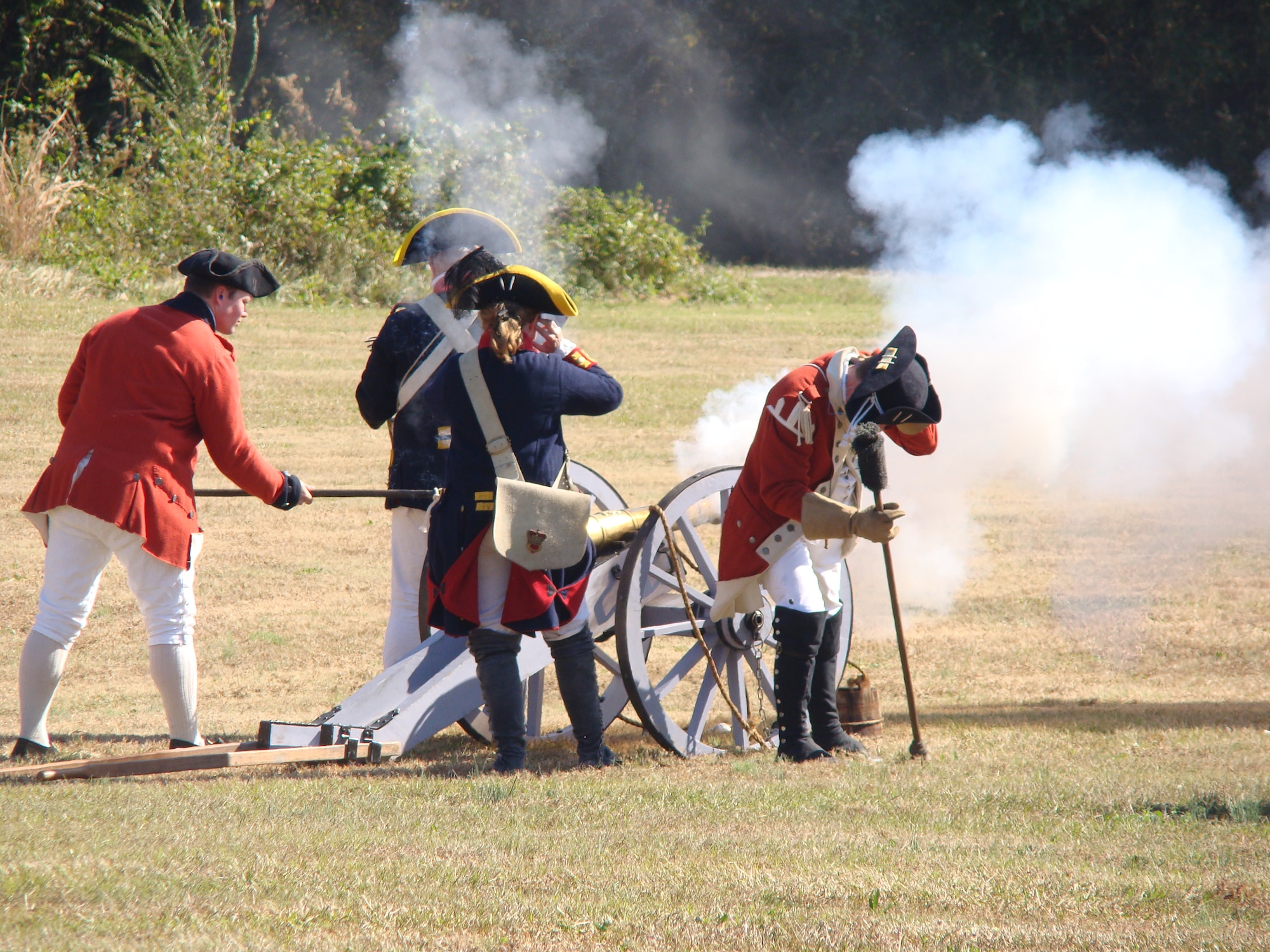 Portraying soldiers of Great Britain, re-enactors fire their cannon at advancing rebel troops of the American Continental Army, at Camden, S.C., about 25 miles north of Shaw Air Force Base, Nov. 3, 2012. More than 200 re-enactors, including many military veterans, brought the Camden battlefield back to life 232 years after the event. (U.S. Air Force photo by Rob Sexton/Released)