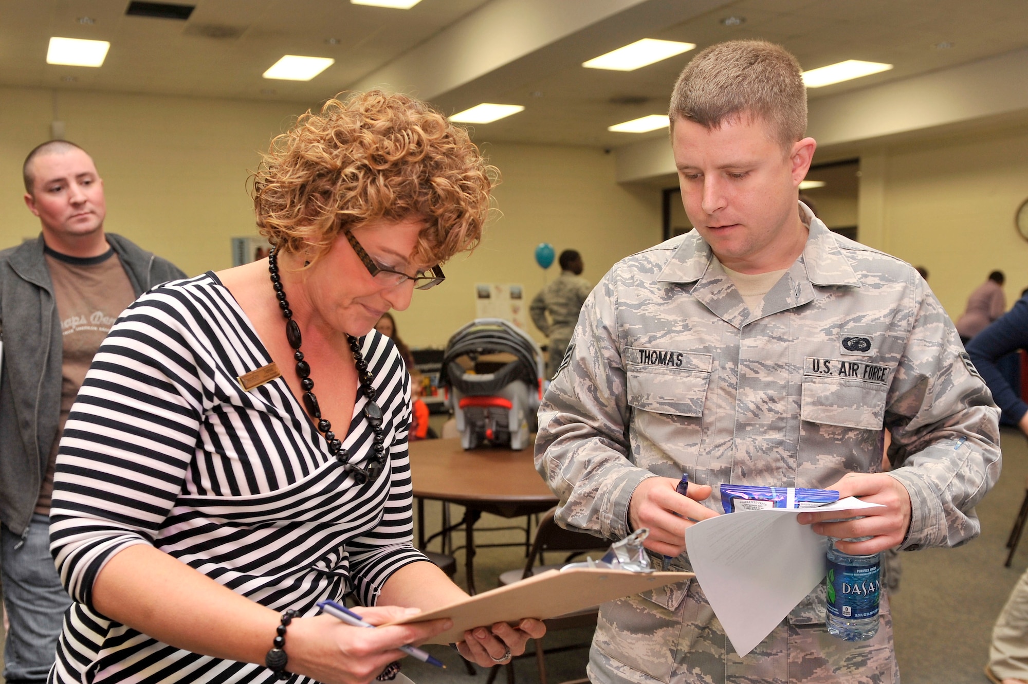 Jamie Miller, General Manager, Southern Group, Forest City Military Community assists Senior Airman Corey Thomas, Disbursing Technician, Finance Section, Air Force Central Command, Shaw Air Force Base, S.C., in understanding the phasing process and helping him determine a date for when he and his family are due to move into newer housing Oct. 30, 2012, Shaw AFB, S.C. (U.S. Air Force photo by Staff Sgt. Ave I. Young/Released)