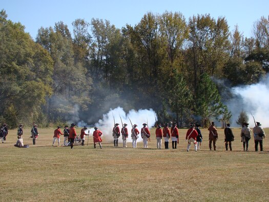 Portraying soldiers of Great Britain, re-enactors face cannons fired by rebel soldiers of the American colonies, about 25 miles north of Shaw Air Force Base at Camden, S.C., Nov. 3, 2012. More than 200 re-enactors, including many military veterans, brought the battlefield back to life 232 years after the event. (U.S. Air Force photo by Rob Sexton/Released)