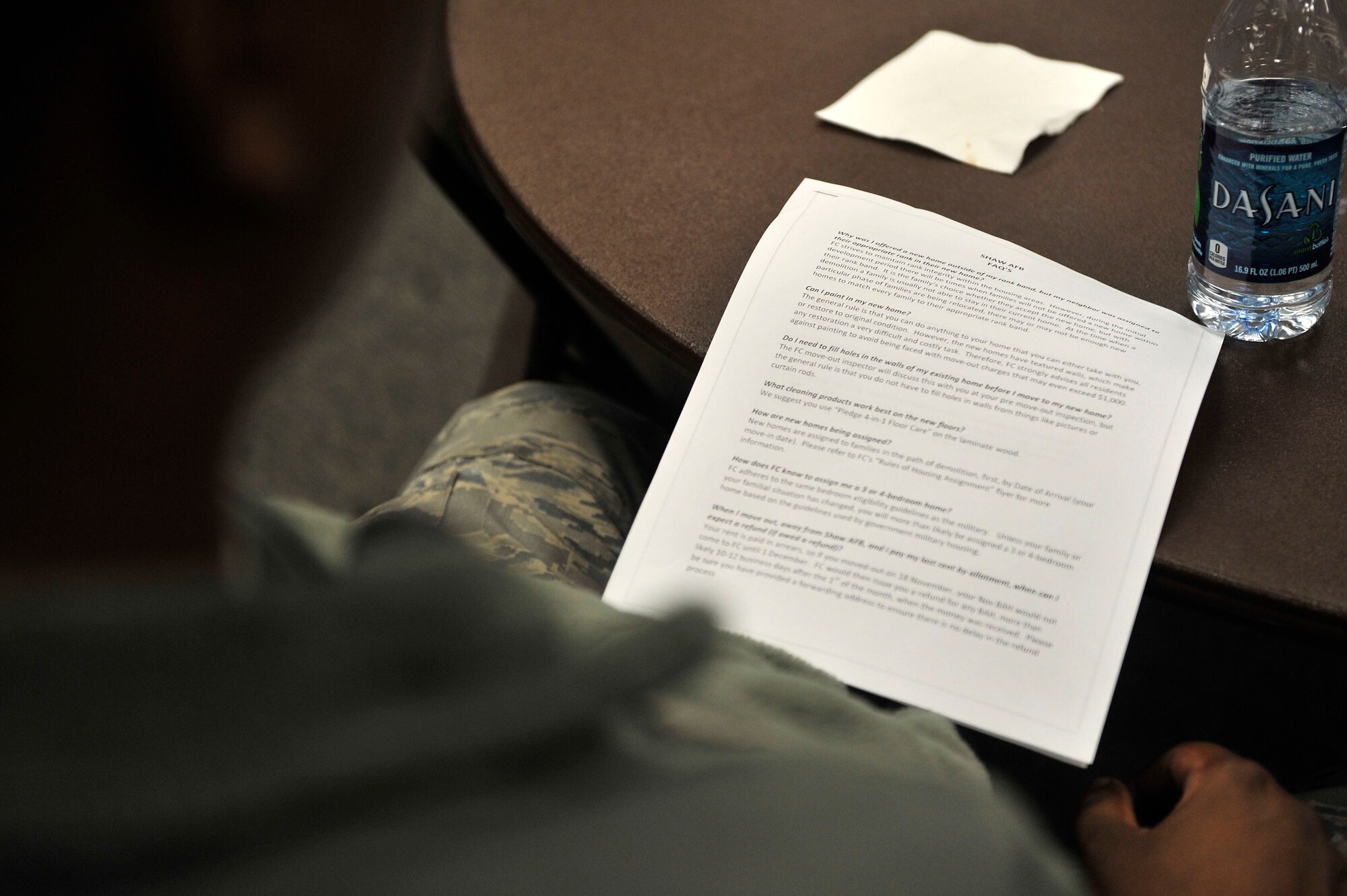 A member of the base housing community reads over “Frequently Asked Questions” during the Forest City Town Hall, held inside the Base Community Center, Oct. 30, 2012, S.C. The town hall is an open forum, held quarterly, where residents have a chance to voice any concerns about their homes and phasing plans.  (U.S. Air Force photo by Staff Sgt. Ave I. Young/Released)