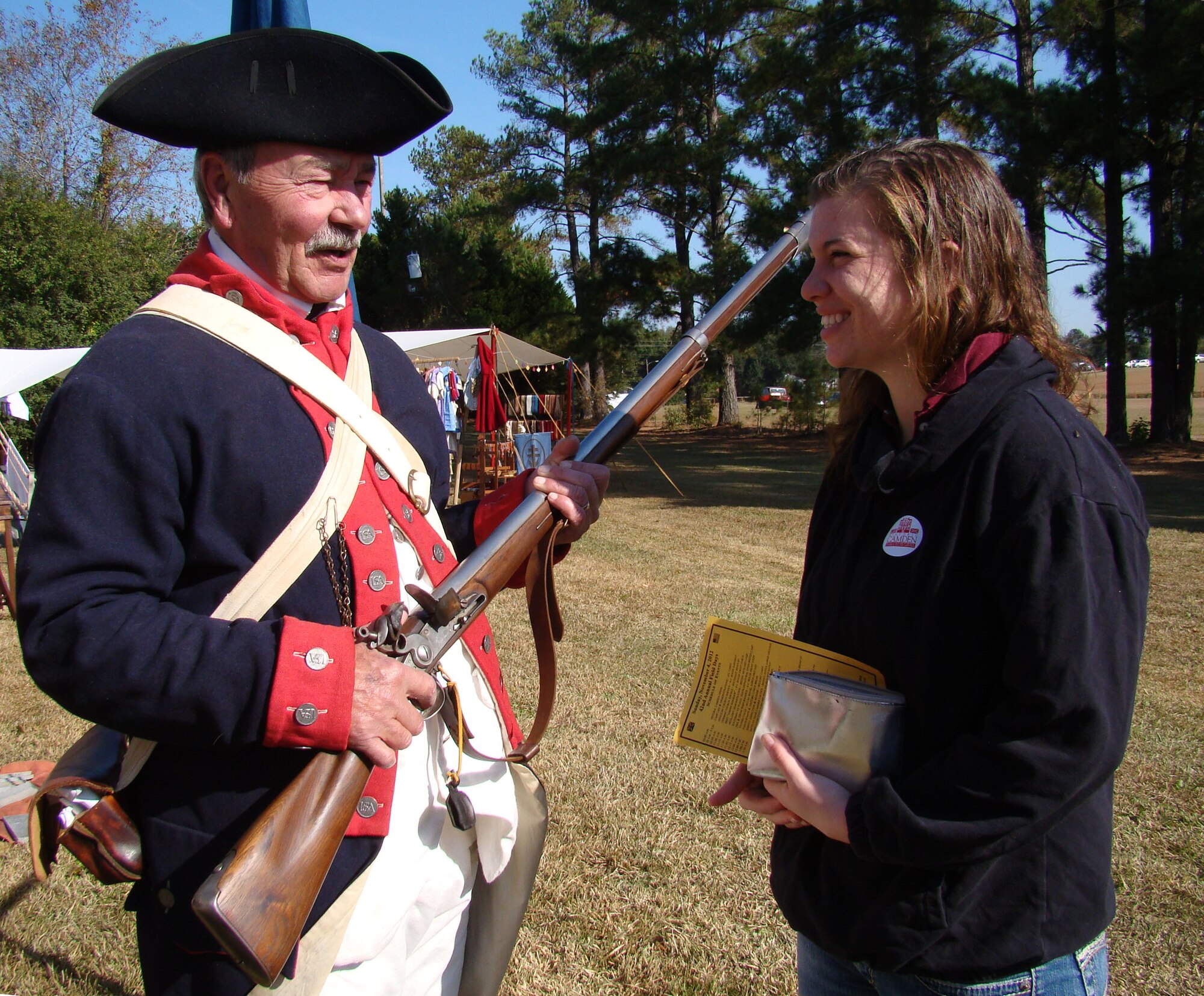 Buddy Bell, who portrays a rebel soldier of the American Revolution, explains his antique rifle to Airman Jodi Lange, 20th Medical Group pharmacy technician, at the Battle of Camden re-enactment Nov. 3, 2012, Camden, S.C. More than 200 actors, including many military veterans, brought the battlefield back to life 232 years after the event. (U.S. Air Force photo by Rob Sexton/Released)