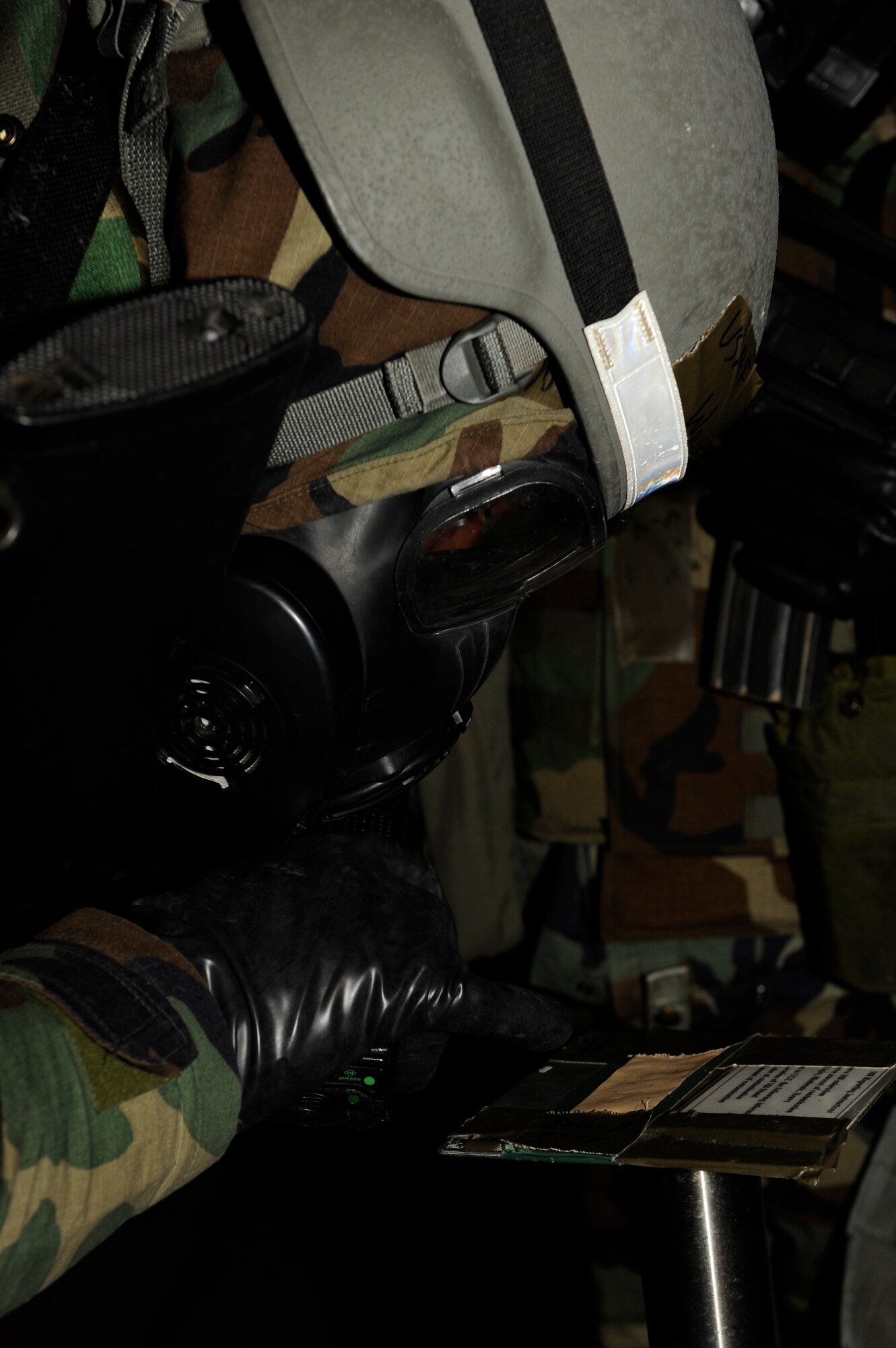 Staff Sgt. Robert Williams, 8th Civil Engineer Squadron checks M9 paper for contamination during exercise Beverly Bulldog 13-1 at Kunsan Air Base, Republic of Korea, Nov. 6, 2012.  Base members monitor for potential contamination and respond accordingly. (U.S. Air Force photo/Senior Airman Marcus Morris)