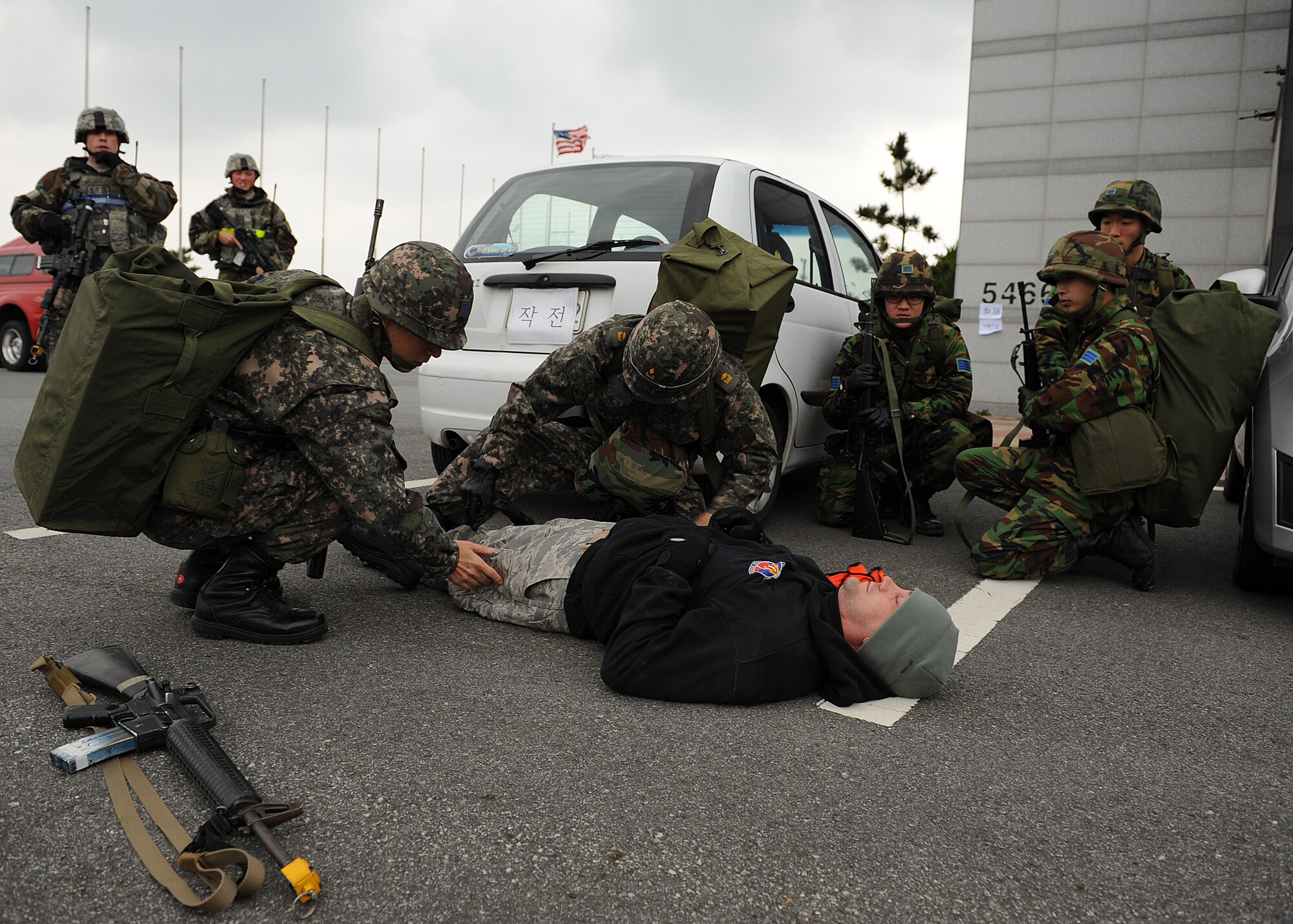 Members of the Republic of Korea air force search an Opposing Forces role-player following a simulated ground attack on Kunsan Air Base, ROK, Nov. 6, 2012. This was part of exercise Beverly Bulldog 13-1 and allowed US and ROK air force personnel to work together during various combat and emergency scenarios. (U.S. Air Force photo/Staff Sgt. Jonathan Fowler)