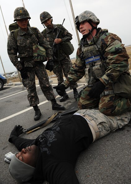 Staff Sgt. Jake Harris, 8th Security Forces Squadron, teaches Republic of Korea air force personnel how to properly search a body during Beverly Bulldog 13-1 on Kunsan Air Base, ROK, Nov. 6, 2012. The exercise was a chance for US and ROK air force members to work together during various simulated combat and mission scenarios. (U.S. Air Force photo/Staff Sgt. Jonathan Fowler)