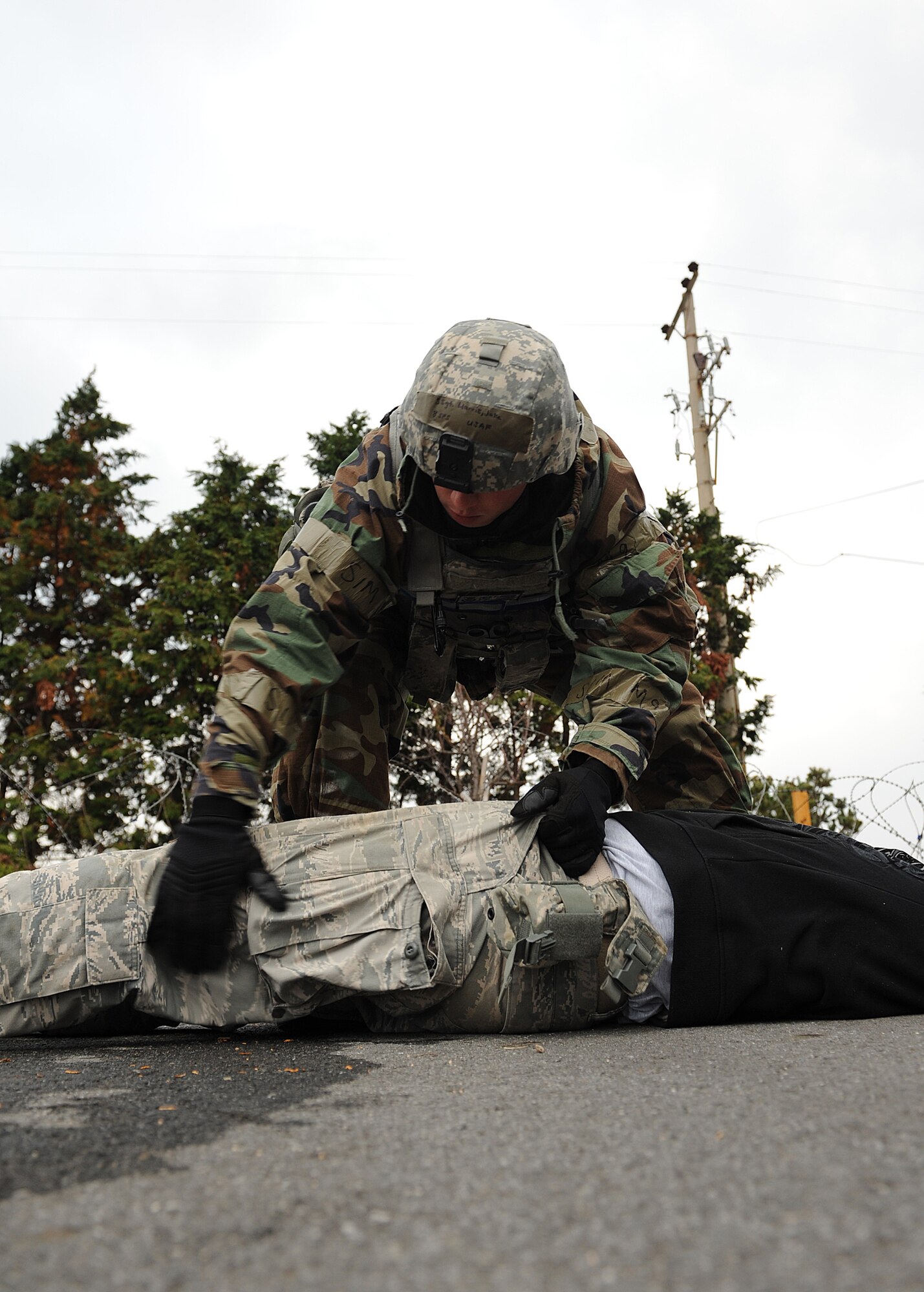 Staff Sgt. Jake Harris, 8th Security Forces Squadron, searches an Opposing Forces role-player following a simulated ground attack on Kunsan Air Base, Republic of Korea, Nov. 6, 2012. This was part of exercise Beverly Bulldog 13-1 which tested the combat and mission capabilities of US and ROK air forces. (U.S. Air Force photo/Staff Sgt. Jonathan Fowler)