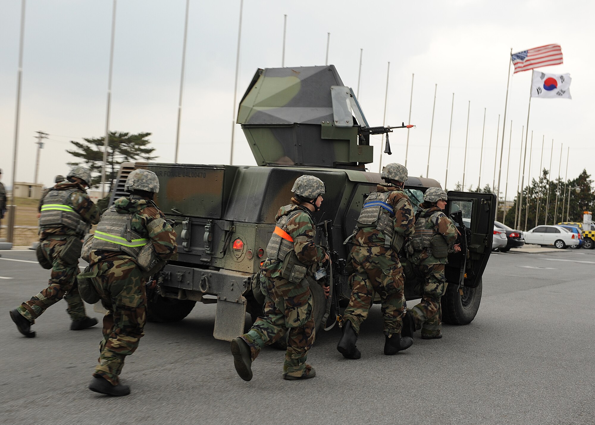 Members of the 8th Security Forces Squadron take cover behind a Humvee while responding to a simulated ground attack on Kunsan Air Base, Republic of Korea, Nov. 6, 2012. This was part of exercise Beverly Bulldog 13-1, which presented various scenarios for US and ROK air force personnel to respond to. (U.S. Air Force photo/Staff Sgt. Jonathan Fowler)