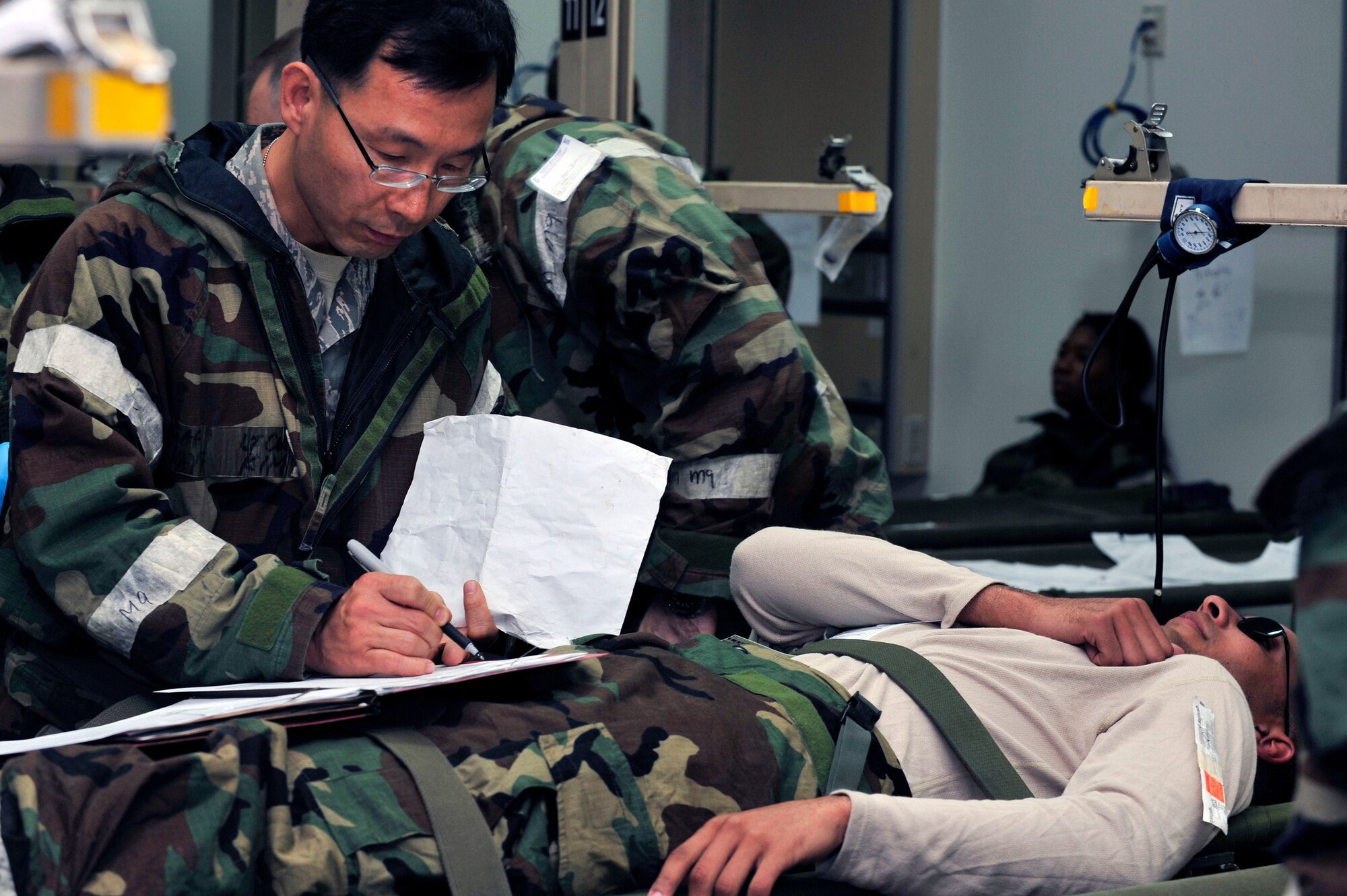 Lt. Col. Wayne Kim, 51st Medical Operations Squadron physician, screens Airman 1st Class Mark Simon, 51st Security Forces Squadron defender, for medical treatment during operational readiness exercise Beverly Bulldog 13-01 at Osan Air Base, Republic of Korea, Nov. 6, 2012. (U.S. Air Force photo/Airman 1st Class Alexis Siekert)