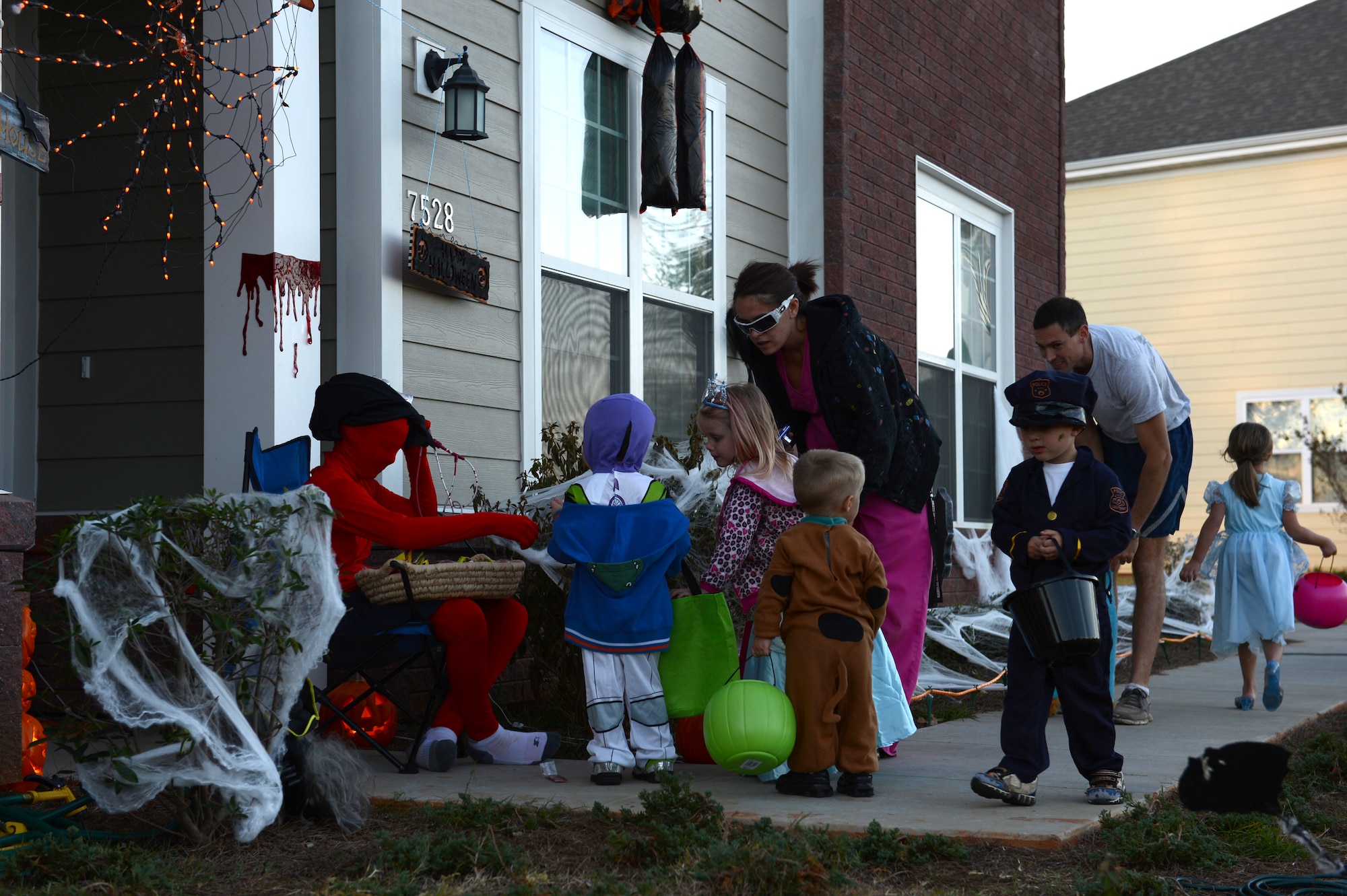 Tallon Hannus handed out candy to trick-or-treaters at Shaw Air Force Base, S.C., Oct. 31, 2012.  Shaw hosted as base housing trick or treat on Halloween. (U.S. Air Force photo by Airman 1st Class Krystal M. Jeffers/Released)