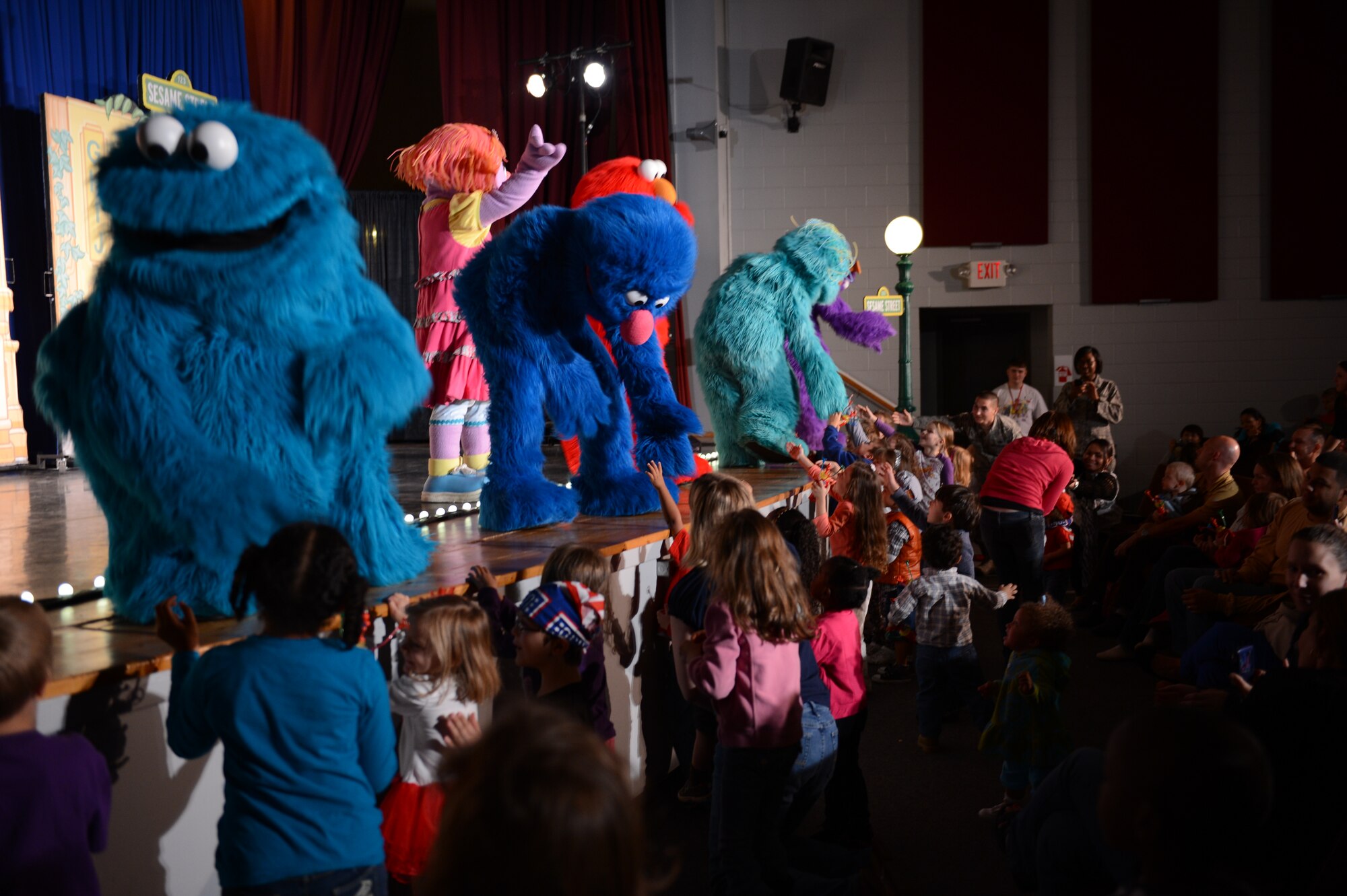Sesame Street characters like the Cookie Monster, Grover, and Rosita shake hands with children at the end of one of their performances at Shaw Air Force Base, S.C., Nov 1, 2012. Sesame Street held four shows at Shaw. (U.S. Air Force photo by Airman 1st Class Krystal M. Jeffers/Released)