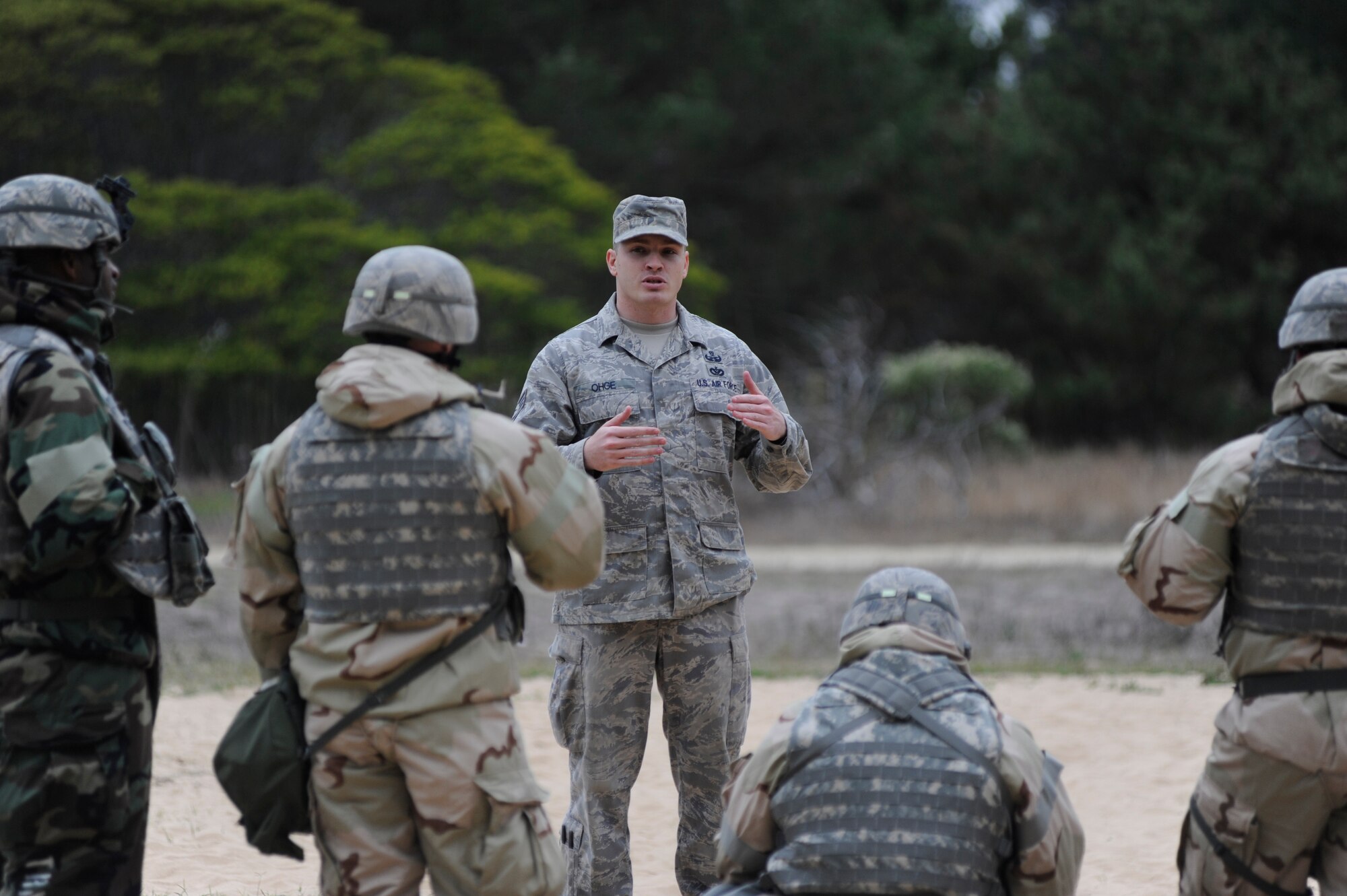 VANDENBERG AIR FORCE BASE, Calif. -- Staff Sgt. Stephen Ohge, 30th Civil Engineer Squadron Explosive Ordnance Disposal trainer, explains EOD procedures to a group of Vandenberg airmen during deployment readiness training at Cocheo Park, Thursday, Nov. 1, 2012. Explosive Ordnance Disposal is one of many essential skills on which Airmen are evaluated as they prepare for deployment. (U.S. Air Force photo/Michael Peterson).