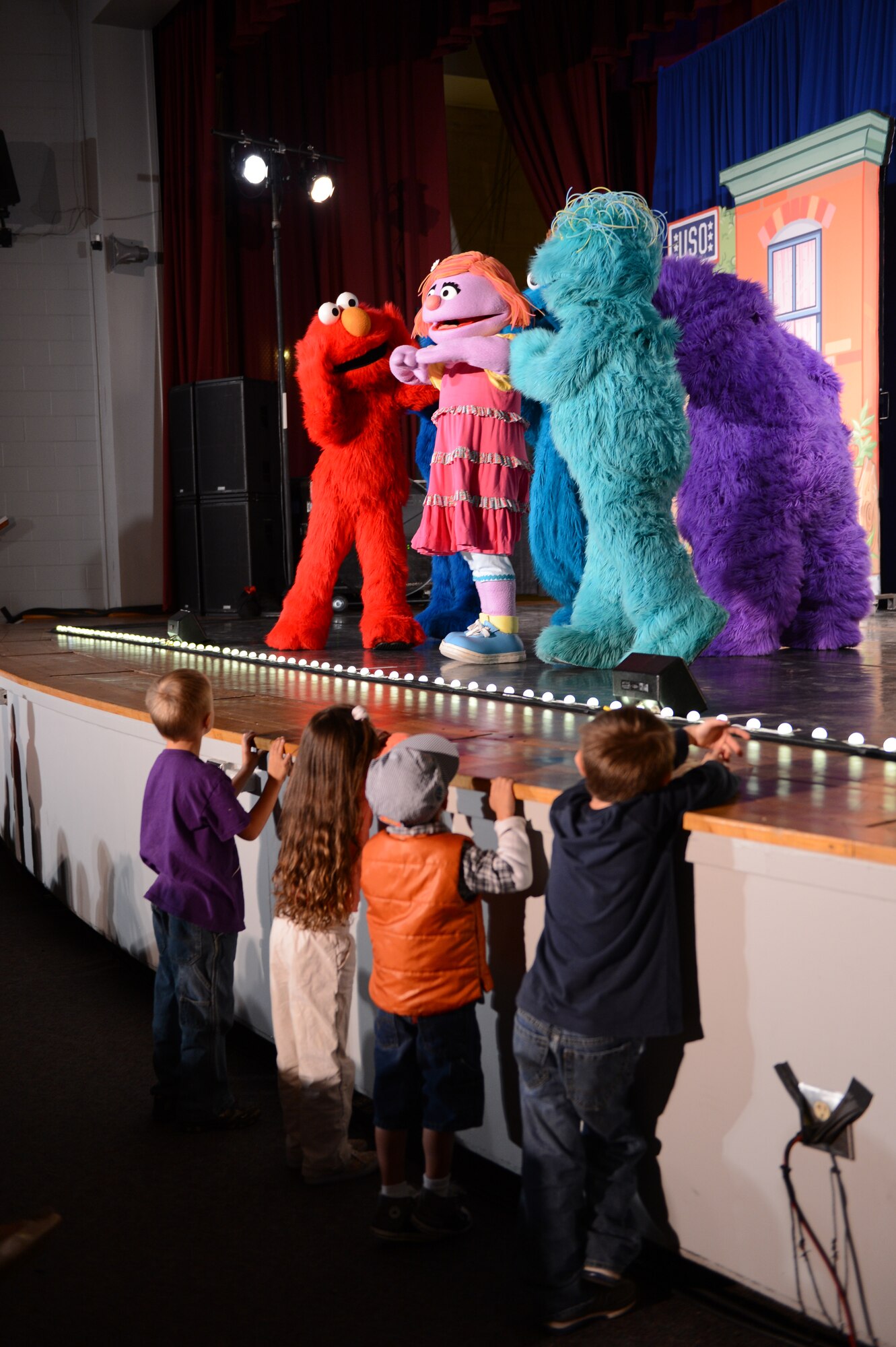 Children stand at the stage’s edge as they watch a performance by the Sesame Street at Shaw Air Force Base, S.C., Nov. 1, 2012. The show focused on a new friend of Elmo’s, named Katie, who was from a military family and was about to relocated to a new town. (U.S. Air Force photo by Airman 1st Class Krystal M. Jeffers/Released)