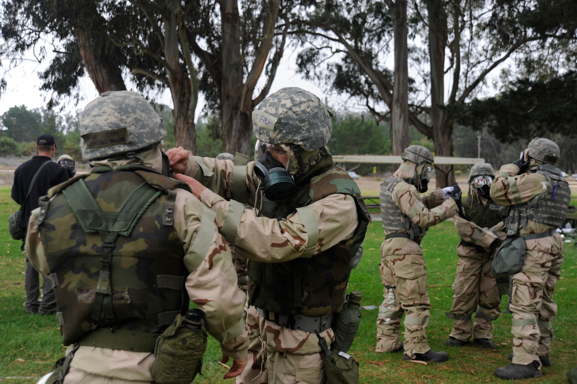 VANDENBERG AIR FORCE BASE, Calif. --
A team of Vandenberg airmen practice suiting-up in Chemical, Biological, Radiological, Nuclear protective gear during deployment readiness training at Cocheo Park Thursday, Nov. 1, 2012. The use of CBRN protective gear is one of many essential skills on which Airmen are evaluated as they prepare for deployment. (U.S. Air Force photo/Michael Peterson)