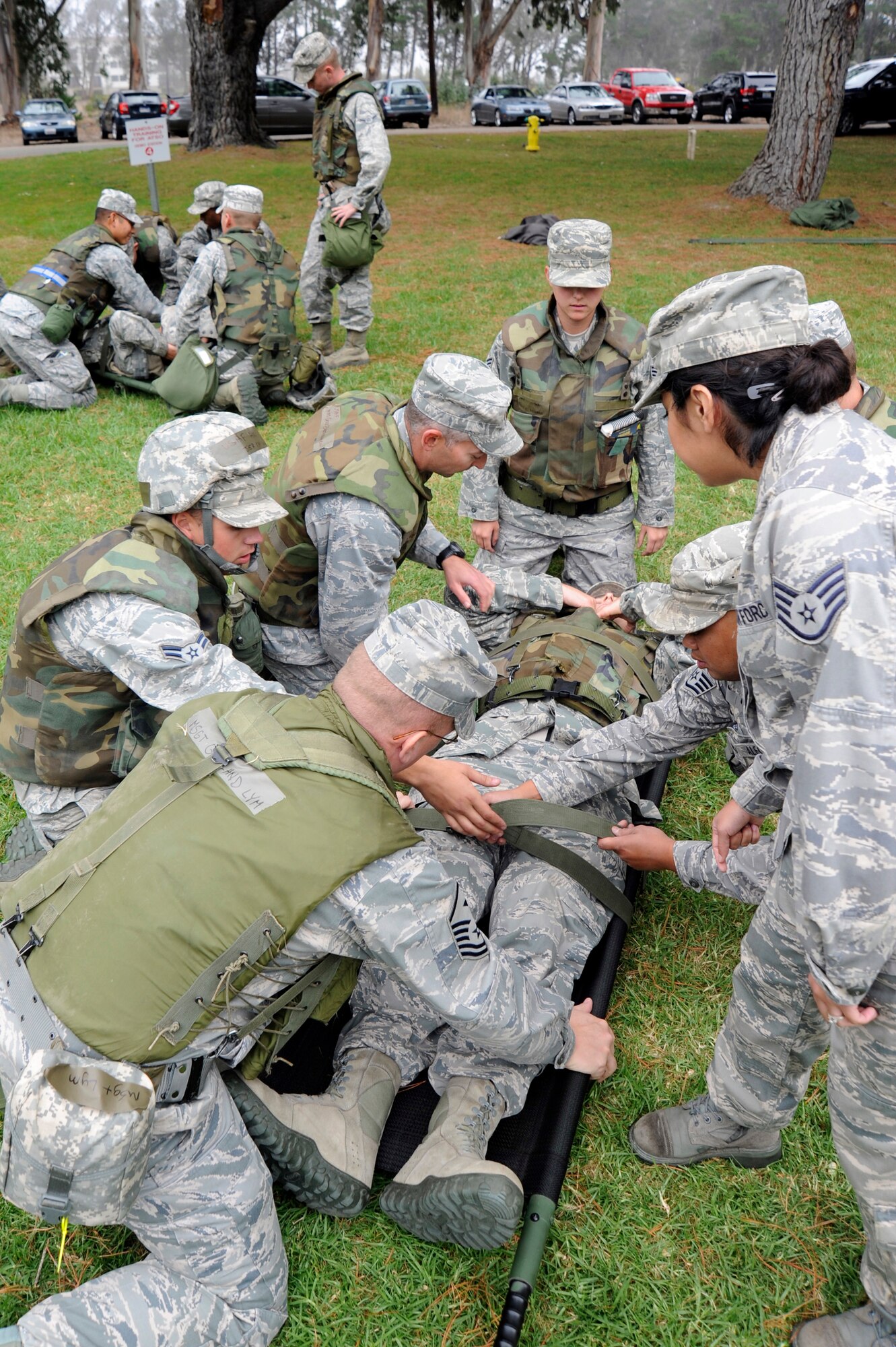 VANDENBERG AIR FORCE BASE, Calif. --
Teams work to secure two wounded Airmen for stretcher transport during deployment readiness training at Cocheo Park Thursday, Nov. 1, 2012. Stretcher transport is a part of Self-Aid and Buddy Care, one of many skills on which Airmen are evaluated as they prepare for deployment. (U.S. Air Force photo/Michael Peterson)