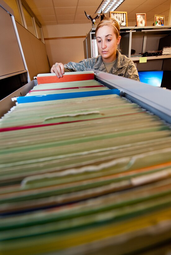Airman 1st Class Aubrey Diethrich, 28th Force Support Squadron military personnel flight assignments specialist, files paperwork in the assignment section in the Rushmore Center on Ellsworth Air Force Base, S.D., Oct. 30, 2012. Airmen who handle assignments are responsible for all processes involved with outprocessing from the base for permanent changes of station, retirements or discharges. (U.S. Air Force photo by Airmen 1st Class Kate Thornton-Maurer/Released) 