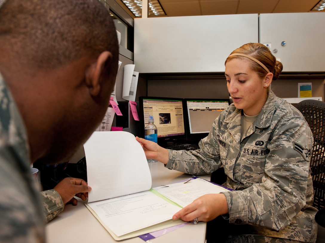 Airman 1st Class Aubrey Diethrich, 28th Force Support Squadron military personnel flight assignments specialist, reviews assignment paperwork with Staff Sgt. Rachid Bundu, 28th FSS MPF promotions specialist, in the Rushmore Center at Ellsworth Air Force Base, S.D., Oct. 30, 2012. MPF offers a variety of services to help ensure Airmen keep their records - military ID cards, assignments, promotions, awards and decorations - current. (U.S. Air Force photo by Airmen 1st Class Kate Thornton-Maurer/Released) 