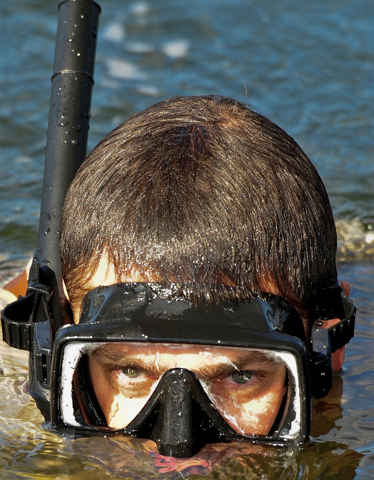 A U.S. Air Force special tactics Airman from the Special Tactics Training Squadron performs a sweep of the Soundside Marina waters during a yearly volunteer marina clean up on Hurlburt Field, Nov. 4, 2012. The STTS Airmen accomplished a large amount of diving minutes, which is essential to gain the necessary qualifications to be a combat scuba diver, but also turned a routine training mission into the opportunity to give back to the community of Hurlburt Field. (U.S. Air Force photo/Airman 1st Class Christopher Williams)
