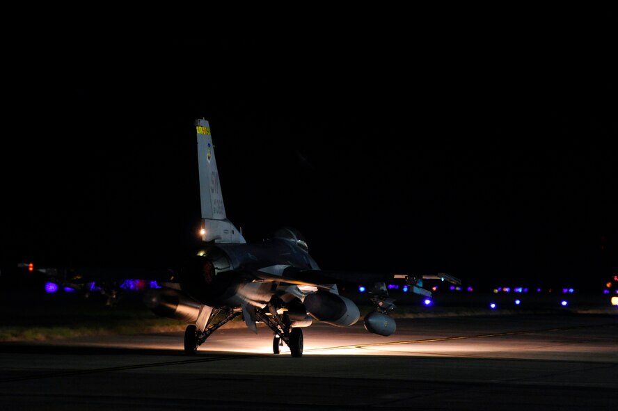 A U.S. Air Force F-16 Fighting Falcon taxies down the Shaw flight line in the dead of night before taking off, Oct. 10, 2012, Shaw Air Force Base, S.C. Several Team Shaw Airmen and F-16 fighter pilots from the 77th Fighter Squadron deployed from Shaw to an undisclosed location in Southwest Asia. (U.S. Air Force photo by Staff Sgt. Kenny Holston/Released)