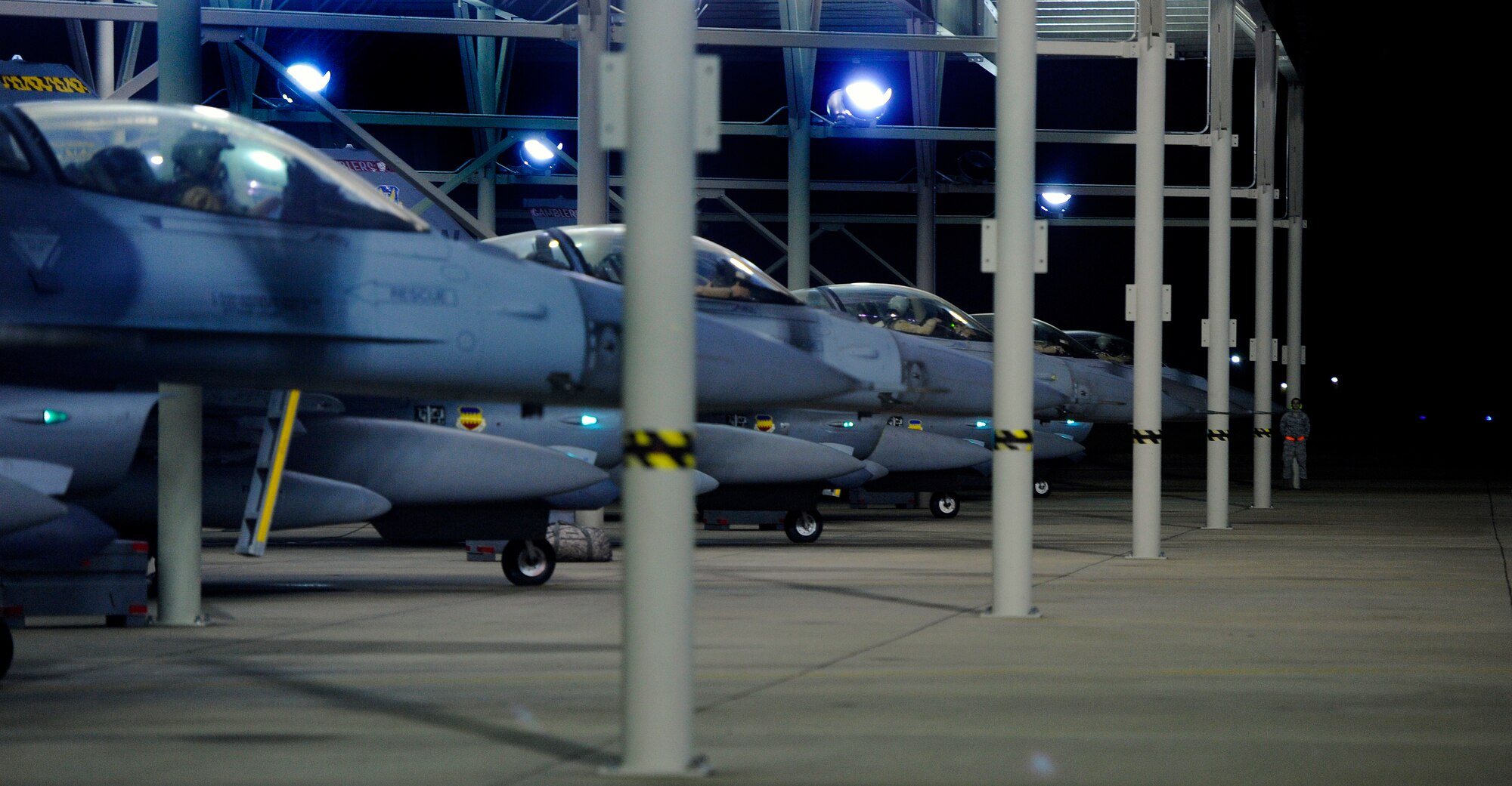 Several U.S. Air Force F-16 Fighting Falcon pilots sit in the cockpits of their jets prior to launching from Shaw, Oct. 10, 2012, Shaw Air Force Base, S.C. Several Team Shaw Airmen and F-16 fighter pilots from the 77th Fighter Squadron deployed from Shaw to an undisclosed location in Southwest Asia. (U.S. Air Force photo by Staff Sgt. Kenny Holston/Released)