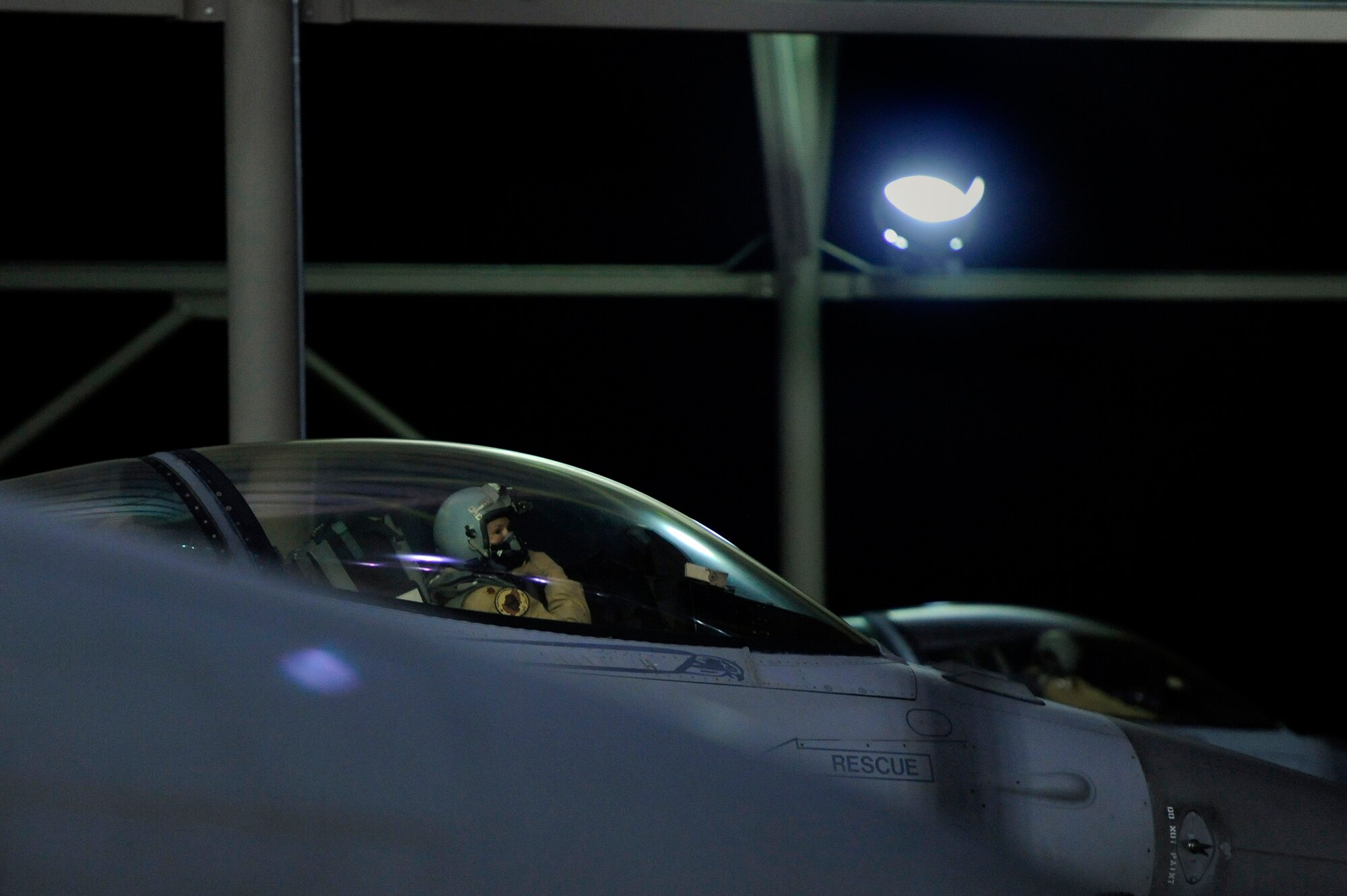 A U.S. Air Force fighter pilot assigned to the 77th Fighter Squadron communicates with her crew chief who is on the ground prior to take-off, Oct. 10, 2012, Shaw Air Force Base, S.C. Several Team Shaw Airmen and F-16 fighter pilots from the 77th Fighter Squadron deployed from Shaw to an undisclosed location in Southwest Asia. (U.S. Air Force photo by Staff Sgt. Kenny Holston/Released)