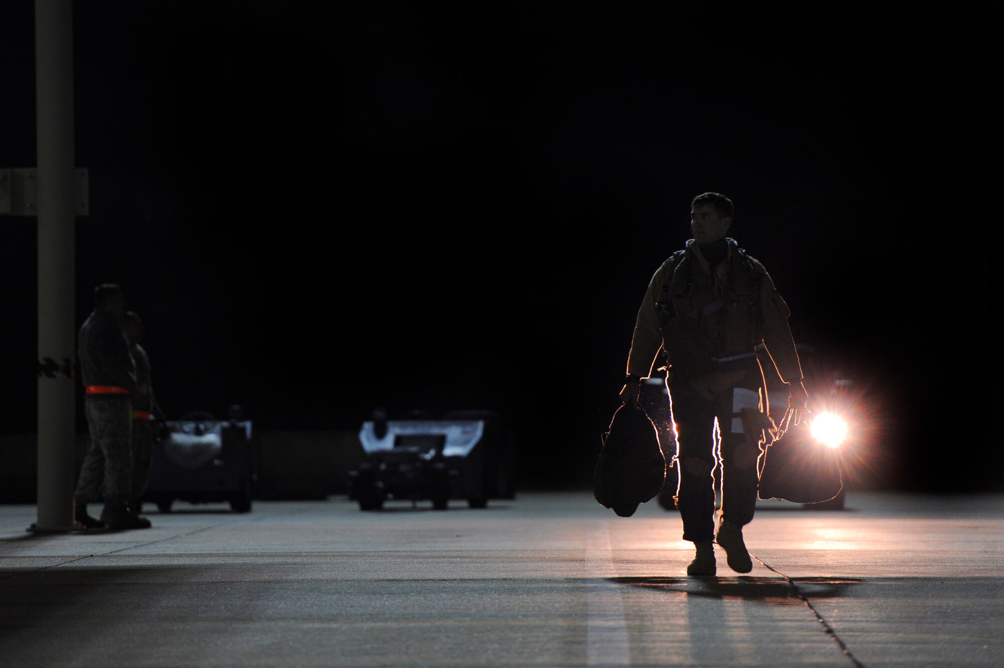 A U.S. Air Force fighter pilot assigned to the 77th Fighter Squadron makes his way to his F-16 Fighting Falcon in preparation for a deployment to an undisclosed location in Southwest Asia, Oct. 10, 2012, Shaw Air Force Base, S.C. Several Team Shaw Airmen and F-16 fighter pilots from the 77th Fighter Squadron deployed from Shaw. (U.S. Air Force photo by Staff Sgt. Kenny Holston/Released) 