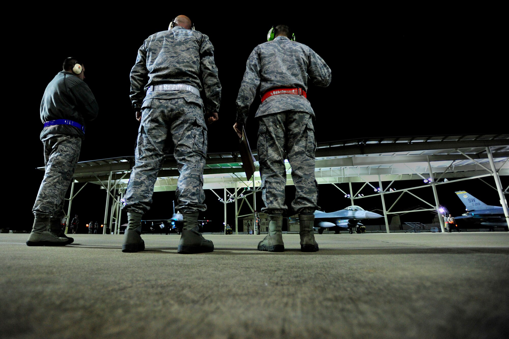 A U.S. Air Force officers and senior enlisted members look on as crew chiefs communicate with F-16 Fighting Falcon pilots as the jets are prepared for take-off, Oct. 10, 2012, Shaw Air Force Base, S.C. Several Team Shaw Airmen and F-16 fighter pilots from the 77th Fighter Squadron deployed from Shaw to an undisclosed location in Southwest Asia. (U.S. Air Force photo by Staff Sgt. Kenny Holston/Released)