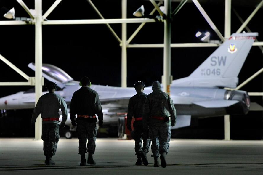 U.S. Air Force maintainers and crew chiefs assigned to the 20th Aircraft Maintenance Squadron make their way across the Shaw flight line to an F-16 Fighting Falcon in order to prep it for take-off, Oct. 10, 2012, Shaw Air Force Base, S.C. Several Team Shaw Airmen and F-16 fighter pilots from the 77th Fighter Squadron deployed from Shaw to an undisclosed location in Southwest Asia. (U.S. Air Force photo by Staff Sgt. Kenny Holston/Released)