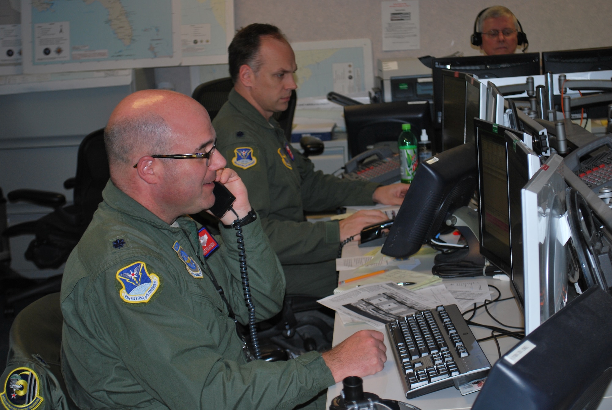 11/6/2012 - Lt. Col. Dave Polacheck and Lt. Col. Pete Kelley, assigned to the 618th Tanker Airlift Control Center at Scott Air Force Base, Ill., monitor the status of operations supporting relief efforts on the East Coast, from the 618th TACC's Contingency Response Cell, Nov. 6. 618th TACC personnel have been working around-the-clock to support relief efforts after Hurricane Sandy struck the region. The 618th TACC's Contingency Response Cell, comprised of mission planners, managers and command-and-control personnel, is specifically dedicated to Air Mobility Command's involvement in relief operations, enabling other 618th TACC personnel to continue planning missions to support other U.S. operations worldwide, including support of Operation Enduring Freedom. (U.S. Air Force photo/Capt. Mauri Slater)