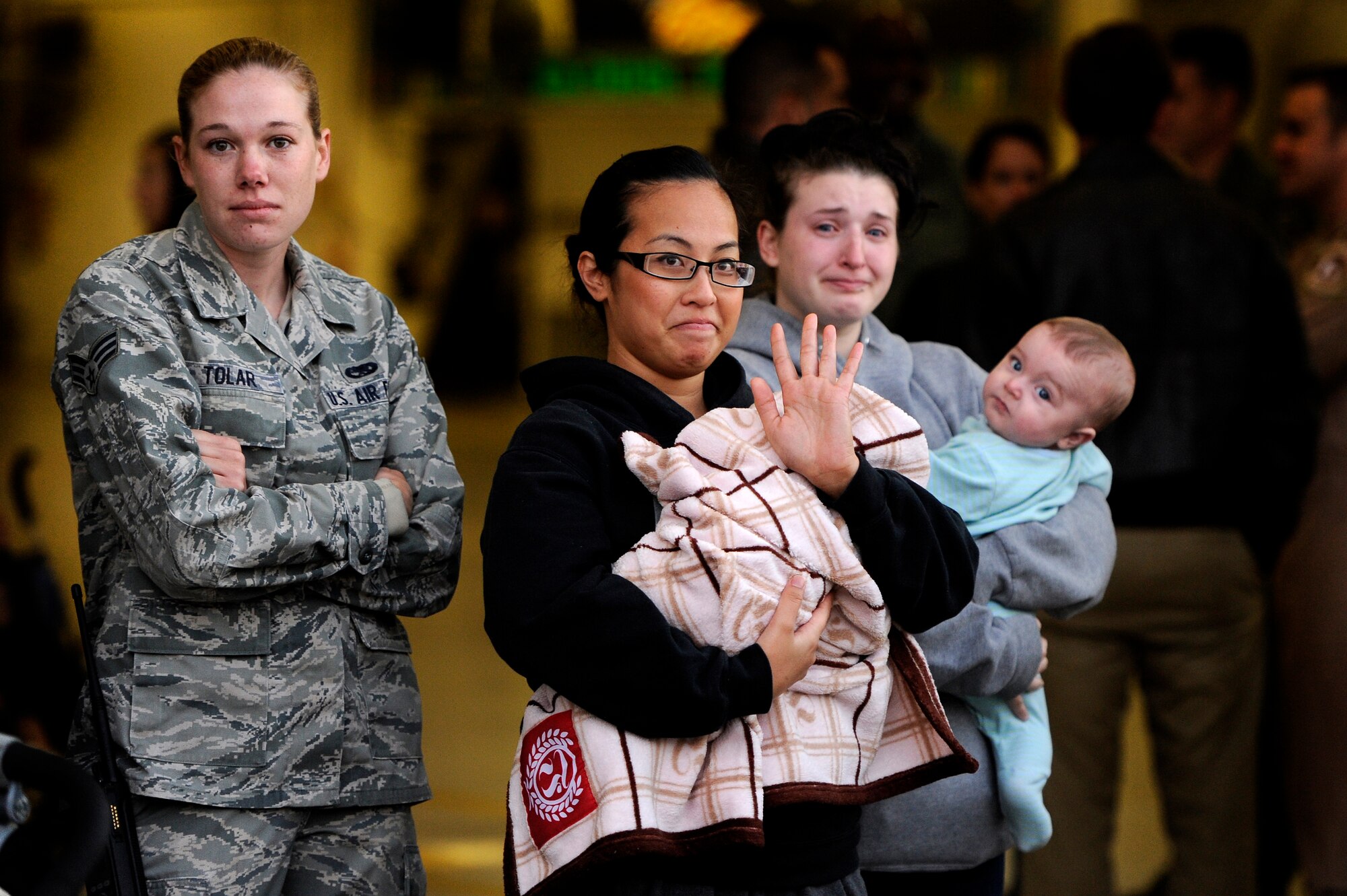 Wives, family members and friends say their final goodbyes as U.S. Air Force Airmen assigned to the 20th Fighter Wing leave for a deployment, Oct. 10, 2012, Shaw Air Force Base, S.C. Several Team Shaw Airmen and F-16 fighter pilots from the 77th Fighter Squadron deployed from Shaw to an undisclosed location in Southwest Asia. (U.S. Air Force photo by Staff Sgt. Kenny Holston/Released)  