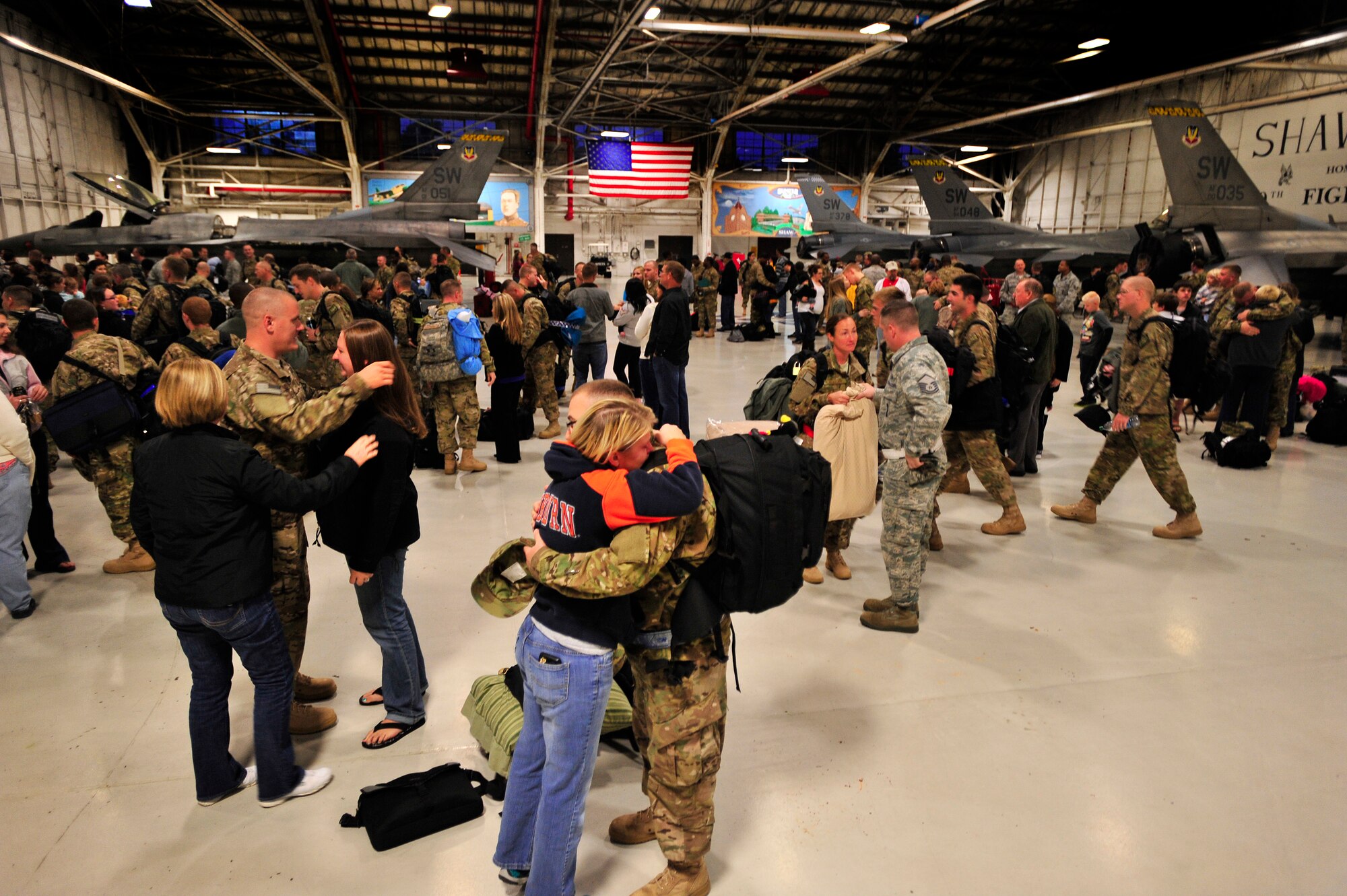 U.S. Air Force Airmen assigned to the 20th Fighter Wing say their goodbyes to loved one as they prepare to leave for a deployment, Oct. 10, 2012, Shaw Air Force Base, S.C. Several Team Shaw Airmen and F-16 fighter pilots from the 77th Fighter Squadron deployed from Shaw to an undisclosed location in Southwest Asia. (U.S. Air Force photo by Staff Sgt. Kenny Holston/Released) 