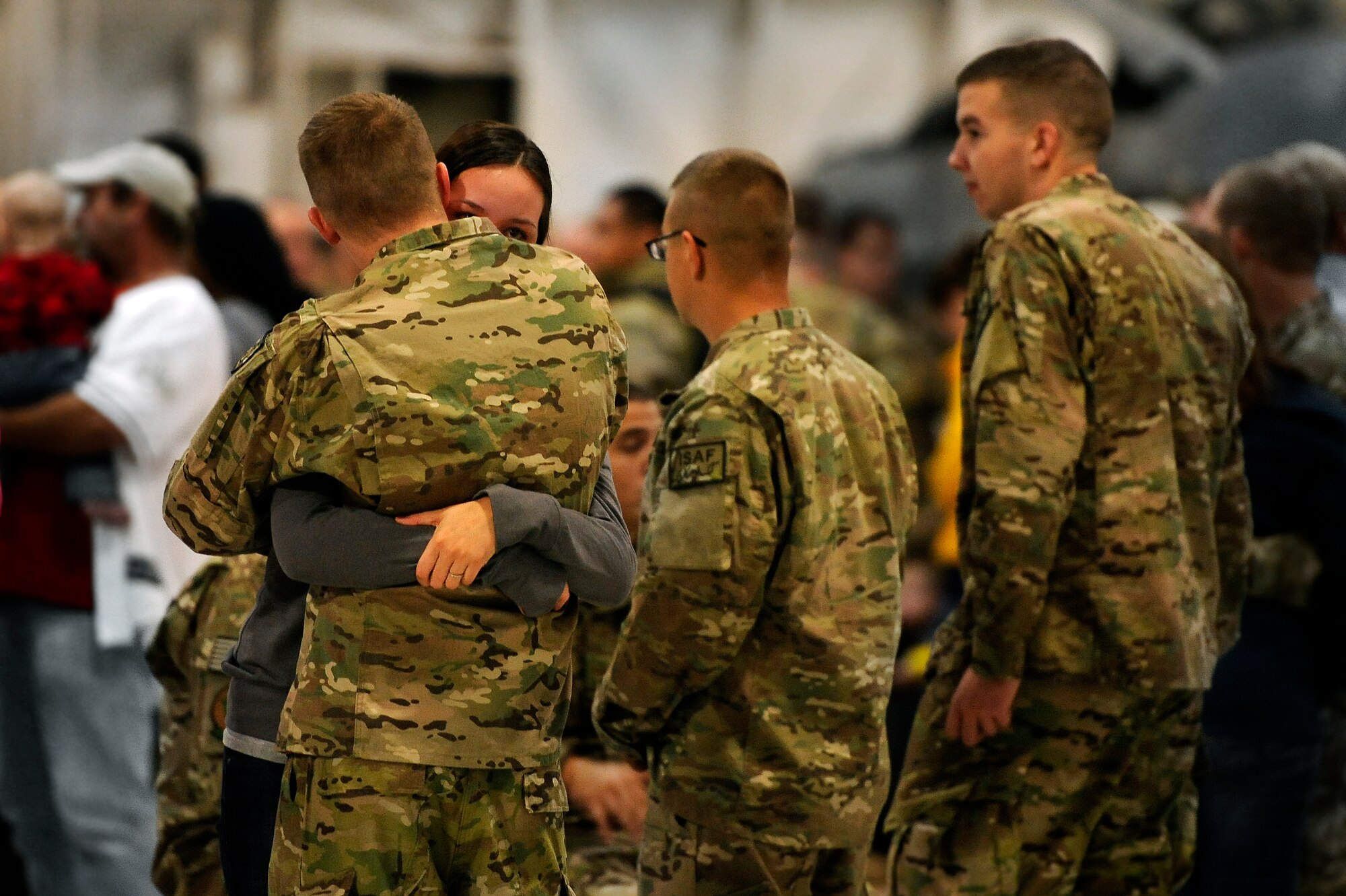 A U.S. Air Force Airman assigned to the 20th Maintenance Group hugs his wife for the final time before departing for a deployment, Oct. 10, 2012, Shaw Air Force Base, S.C. Several Team Shaw Airmen and F-16 fighter pilots from the 77th Fighter Squadron deployed from Shaw to an undisclosed location in Southwest Asia. (U.S. Air Force photo by Staff Sgt. Kenny Holston/Released)
