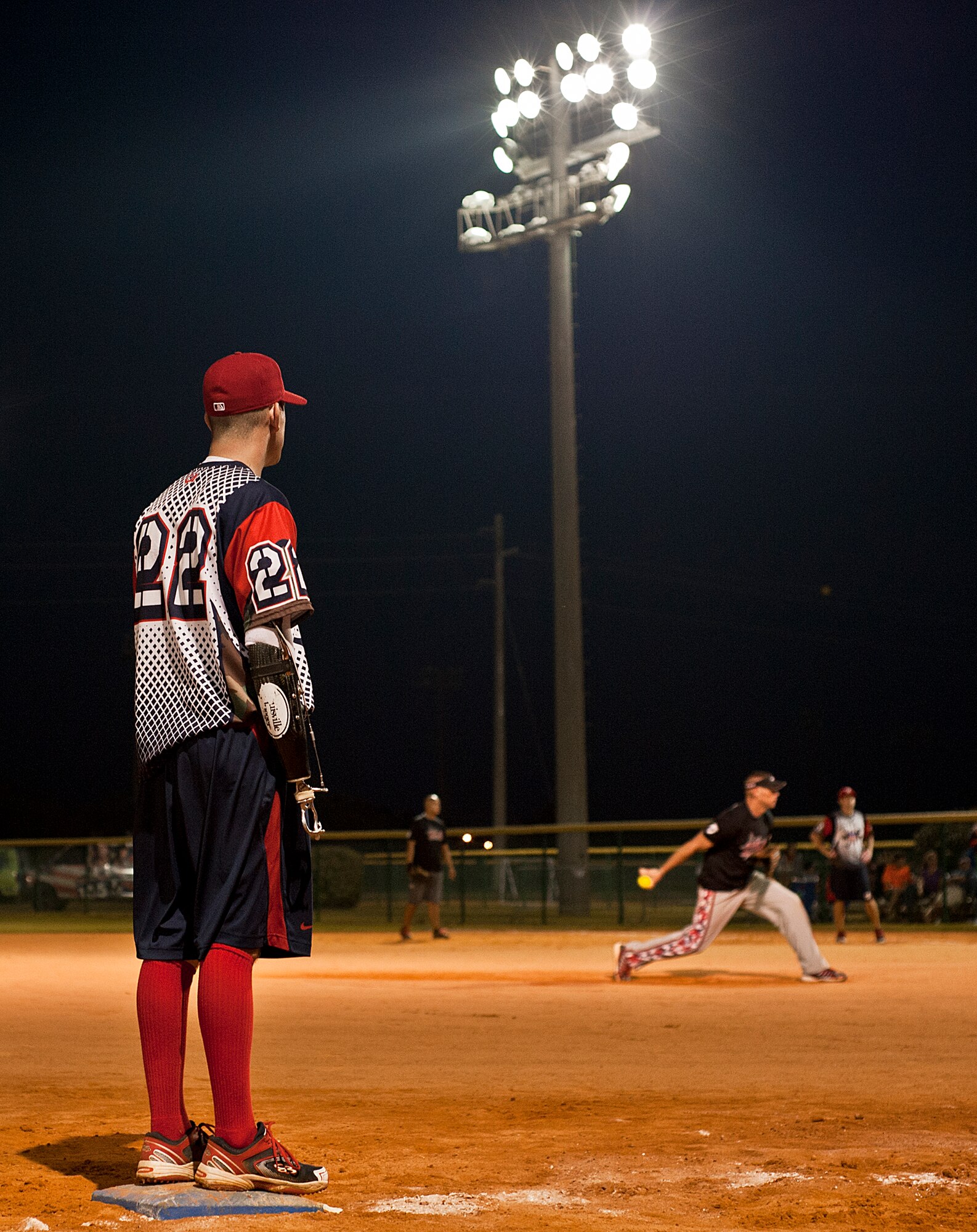 Nate Lindsey, a Wounded Warrior Amputee Softball Team player, watches the Northwest Florida Military Softball Team’s pitcher from third base during a softball game at the Morgan Sports Center in Destin, Fla., Nov. 3rd. WWAST, consisting of service members who lost limbs in battle, joined players from Eglin Air Force Base, Hurlburt Field and the Army 7th Special Forces Group, for a softball game in an effort to raise awareness of the sacrifices and resilience of military members. (U.S. Air Force photo/Randy Gon)