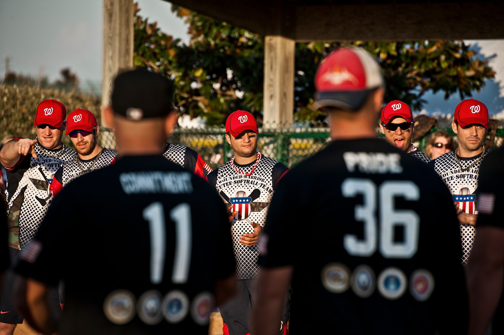 The Wounded Warrior Amputee Softball Team, consisting of service members who have lost limbs in battle, face off with players from the Northwest Florida Armed Services Softball Team during the opening ceremony at the Morgan Sports Center in Destin, Fla., Nov. 3rd. The two teams played to raise awareness of the sacrifices and resilience of military members. (U.S. Air Force photo/Randy Gon)