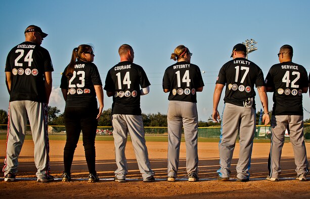 Players from Eglin Air Force Base, Hurlburt Field and the Army 7th Special Forces Group recognize the Wounded Warrior Amputee Softball Team during the opening ceremony at the Morgan Sports Center in Destin, Fla., Nov. 3rd. The two teams played to raise awareness of the sacrifices and resilience of military members. (U.S. Air Force photo/Randy Gon)