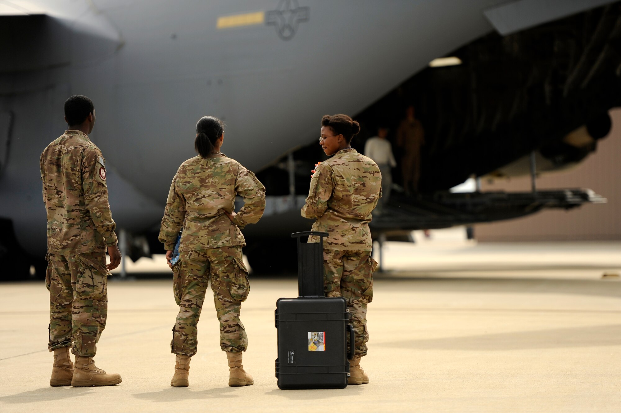 U.S. Air Force Airmen assigned to the 20th Operations Support Squadron look on as the last bit of cargo is loaded on to a C-17 Globemaster III in support of an upcoming deployment, Oct. 5, 2012, Shaw Air Force Base, S.C. Several Team Shaw Airmen and F-16 fighter pilots from the 77th Fighter Squadron deployed from Shaw to an undisclosed location in Southwest Asia. (U.S. Air Force photo by Staff Sgt. Kenny Holston/Released)