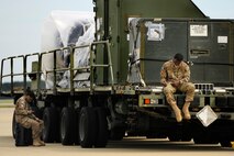 U.S. Air Force Senior Airmen Ebony Starr and Airman 1st Class Matthew Galbreath, both assigned to the 20th Operations Support Squadron sit on the Shaw flight line while waiting to help load cargo on to a C-17 Globemaster III in support of an upcoming deployment, Oct. 5, 2012, Shaw Air Force Base, S.C. Several Team Shaw Airmen and F-16 fighter pilots from the 77th Fighter Squadron deployed from Shaw to an undisclosed location in Southwest Asia. (U.S. Air Force photo by Staff Sgt. Kenny Holston/Released) 
