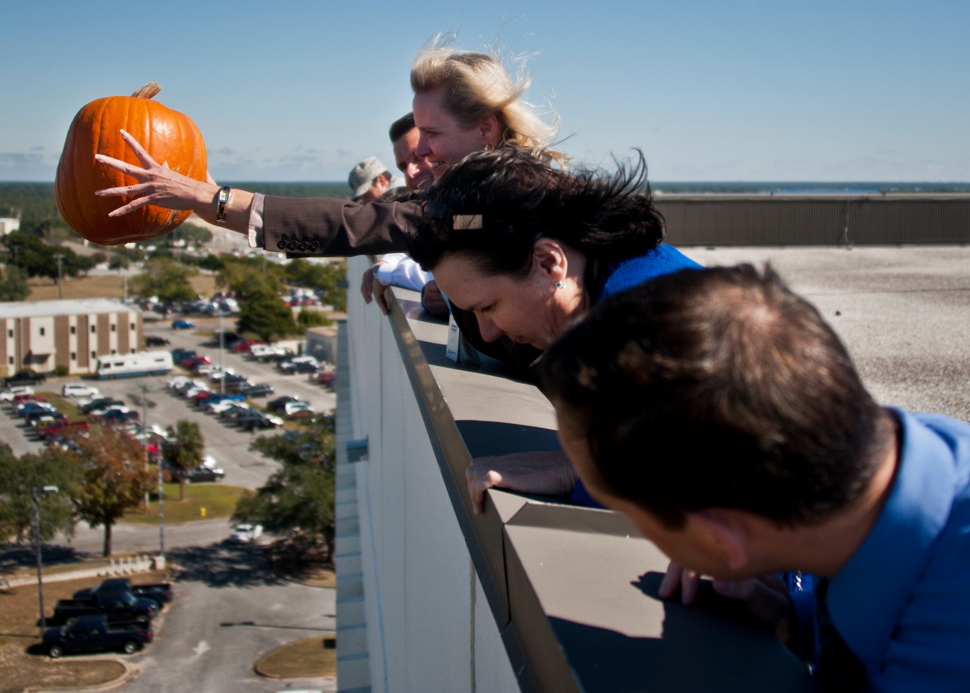 A Team Eglin member tosses a pumpkin off of Bldg. 350 toward a target on the ground during the 9th Annual Pumpkin Toss at Eglin Air Force Base, Fla., Nov. 6. Participants paid $5 for each toss.  Proceeds from the event, went to a Combined Federal Campign charity. (U.S. Air Force photo/Randy Gon)