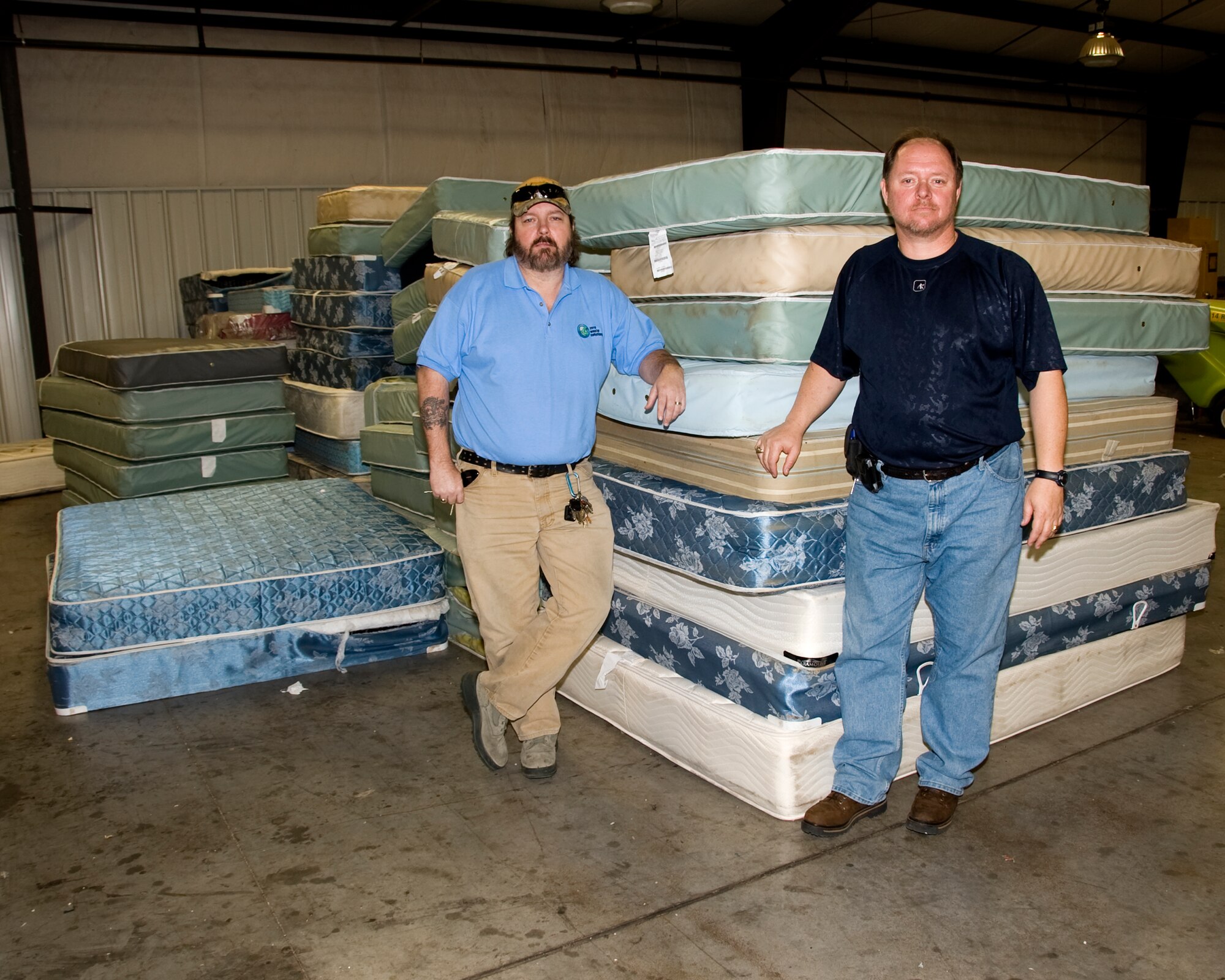 David Scarborough, project manager and Michael Klump, Qualified Recycle Program Manager, 82nd Civil Engineering Squadron, talk about the recycle program for mattresses being stored for pick up by a certified recycling vendor at the Sheppard AFB Recycling Center. (U.S. Air Force photo by Frank H. Carter)